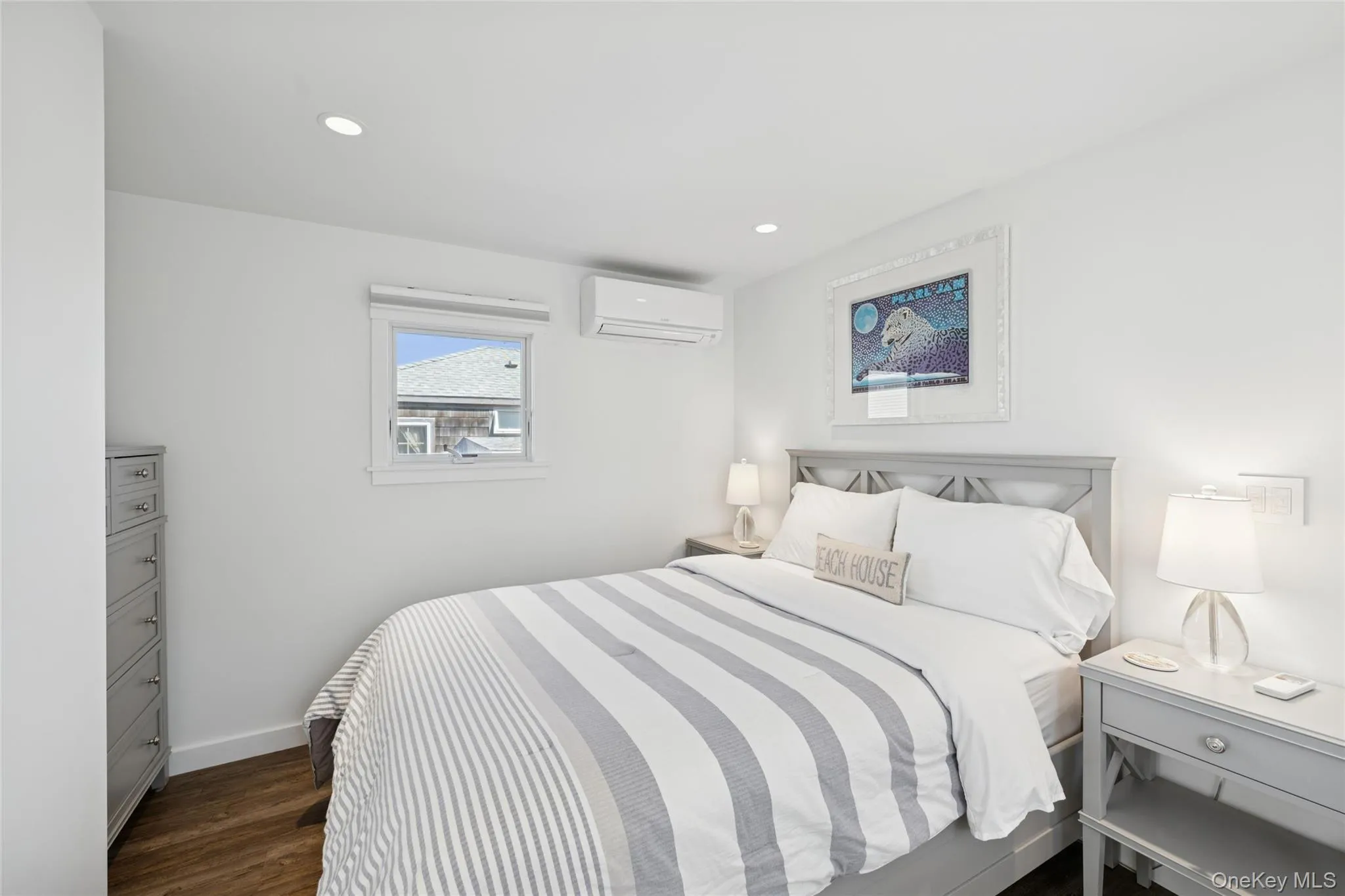 Bedroom featuring dark wood finished floors, an AC wall unit, and recessed lighting Bedroom featuring dark wood finished floors, an AC wall unit, and recessed lighting