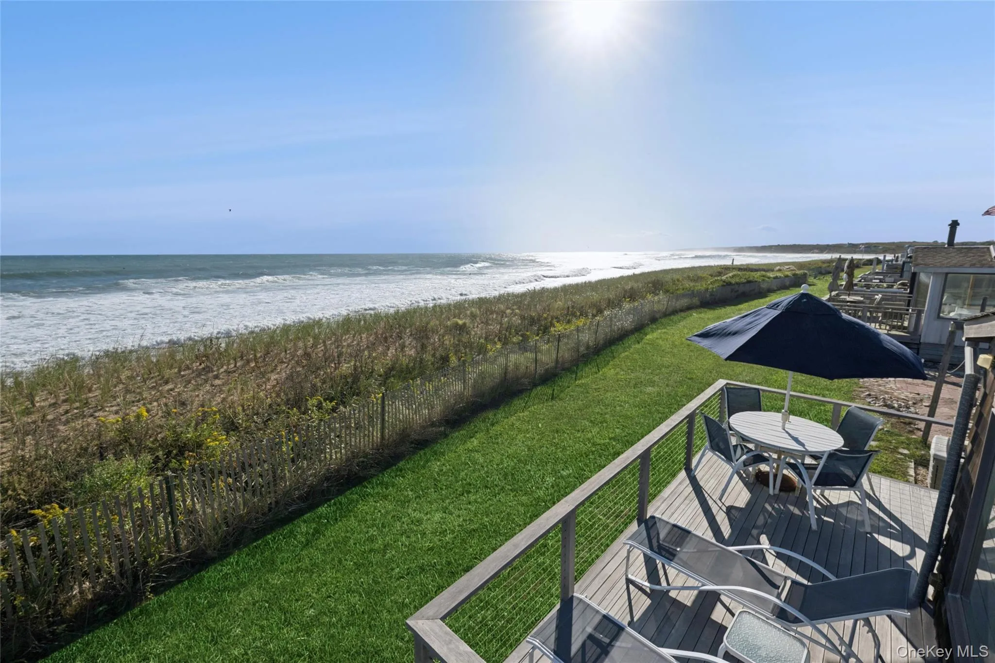 Water view featuring a fenced backyard and nearby beach Water view featuring a fenced backyard and nearby beach