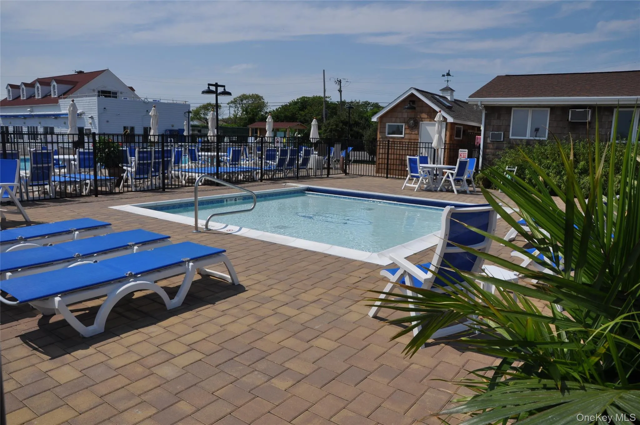 Community pool with a patio area Community pool with a patio area