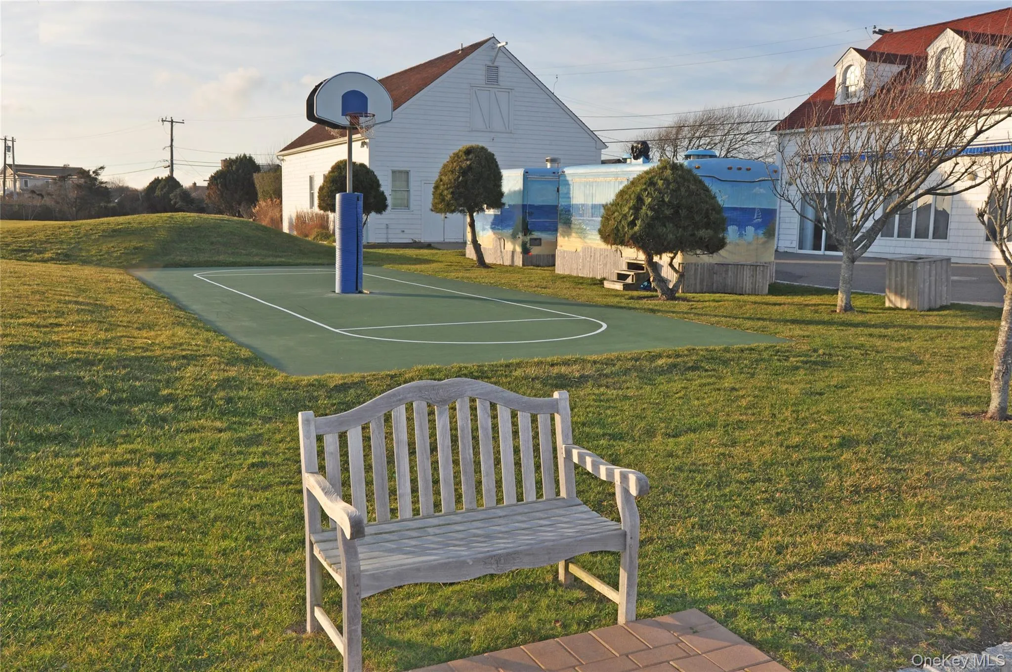 View of basketball court featuring a lawn and community basketball court View of basketball court featuring a lawn and community basketball court