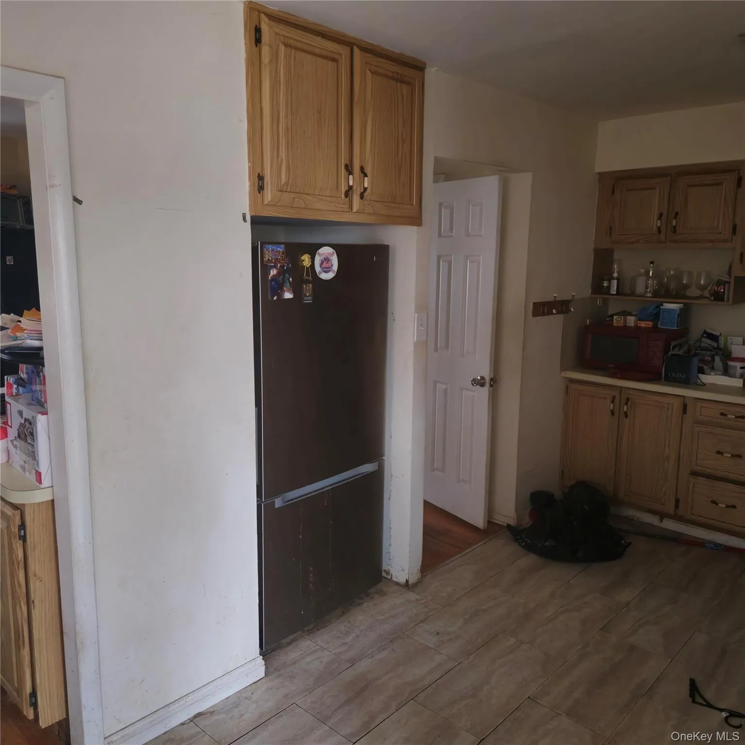 Kitchen with light countertops and freestanding refrigerator Kitchen with light countertops and freestanding refrigerator