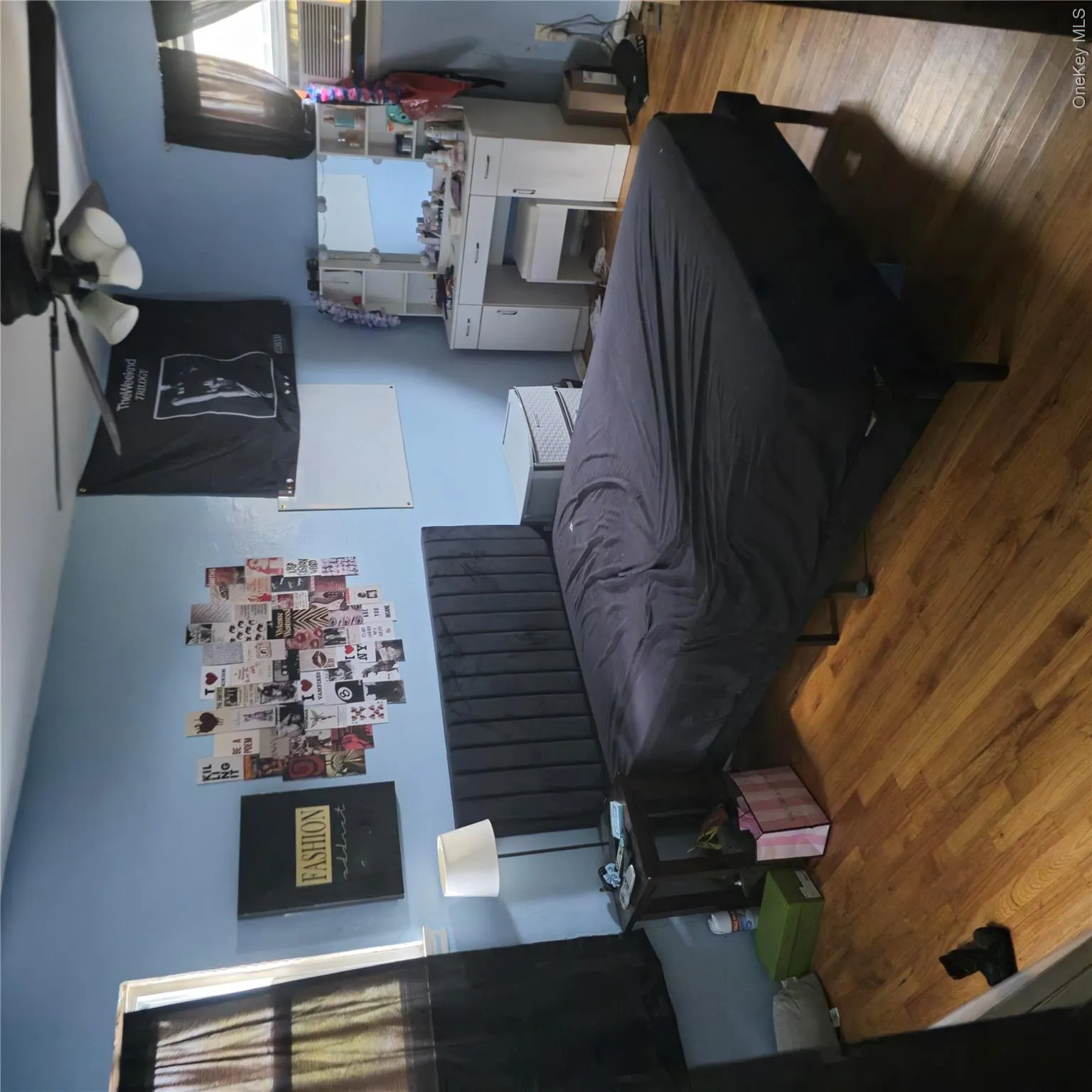 Bedroom featuring wood finished floors, ceiling fan, and cooling unit Bedroom featuring wood finished floors, ceiling fan, and cooling unit