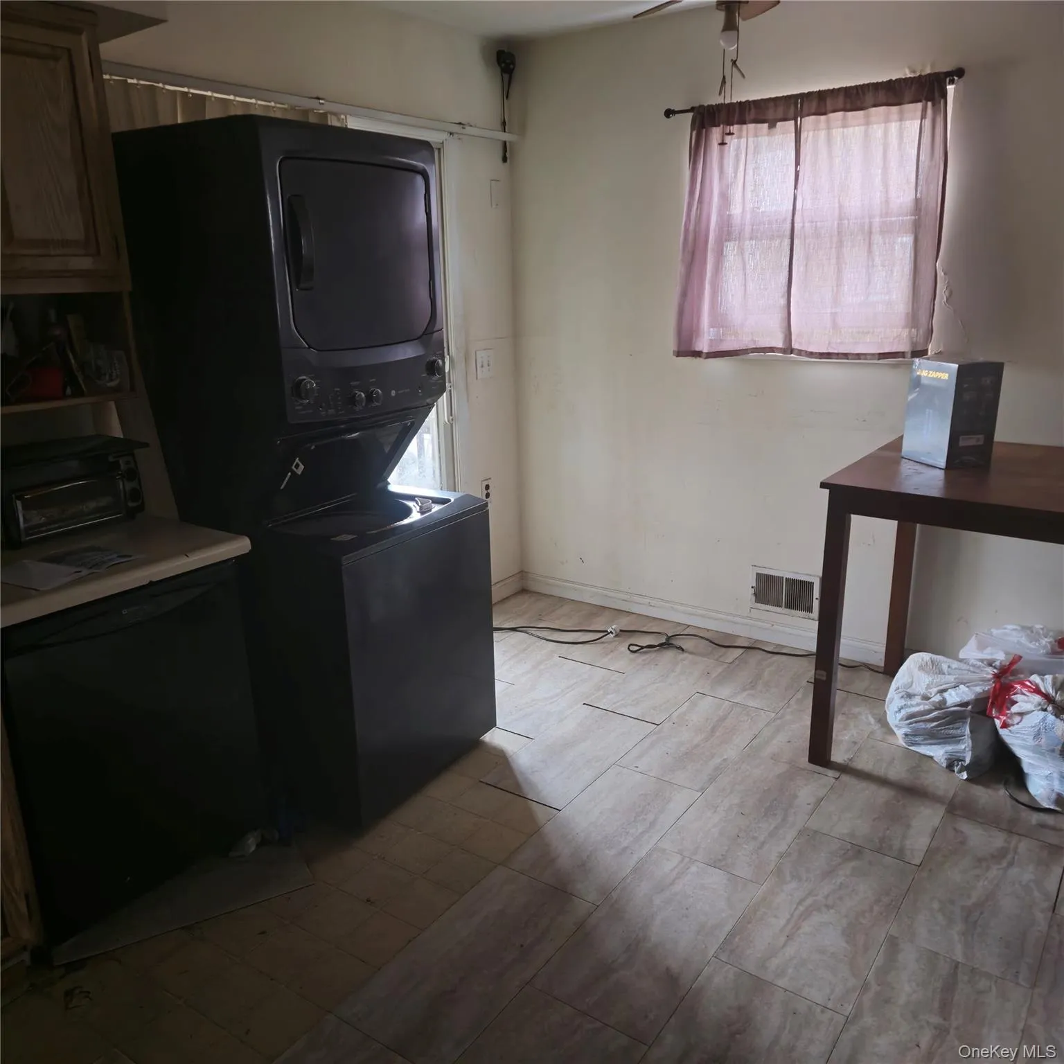Laundry area featuring stacked washing machine and dryer Laundry area featuring stacked washing machine and dryer