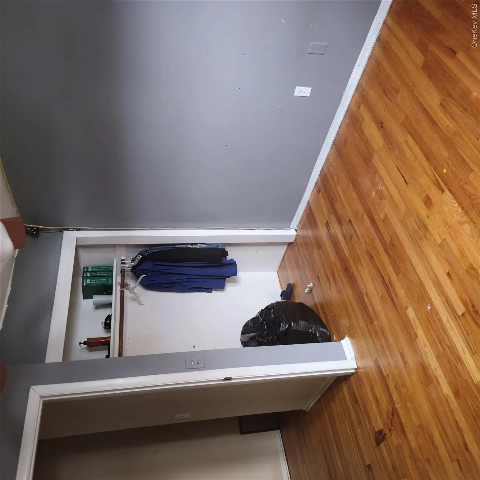 Unfurnished bedroom featuring wood finished floors and a closet Unfurnished bedroom featuring wood finished floors and a closet