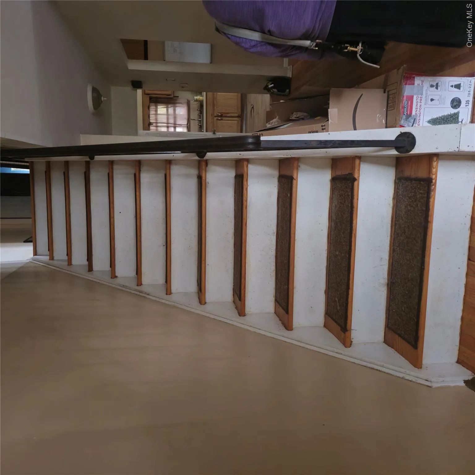 Staircase featuring wood finished floors Staircase featuring wood finished floors