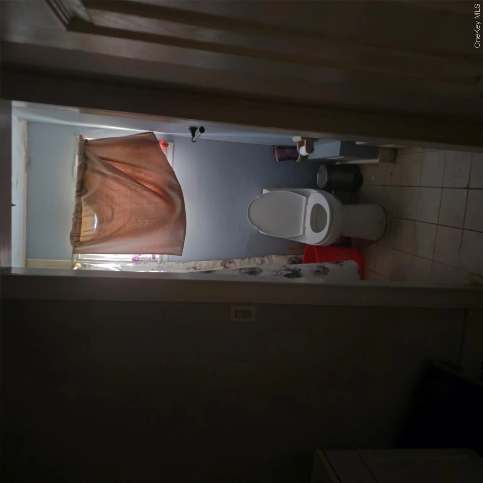 Bathroom featuring light tile patterned floors, vanity, and a shower with shower curtain Bathroom featuring light tile patterned floors, vanity, and a shower with shower curtain