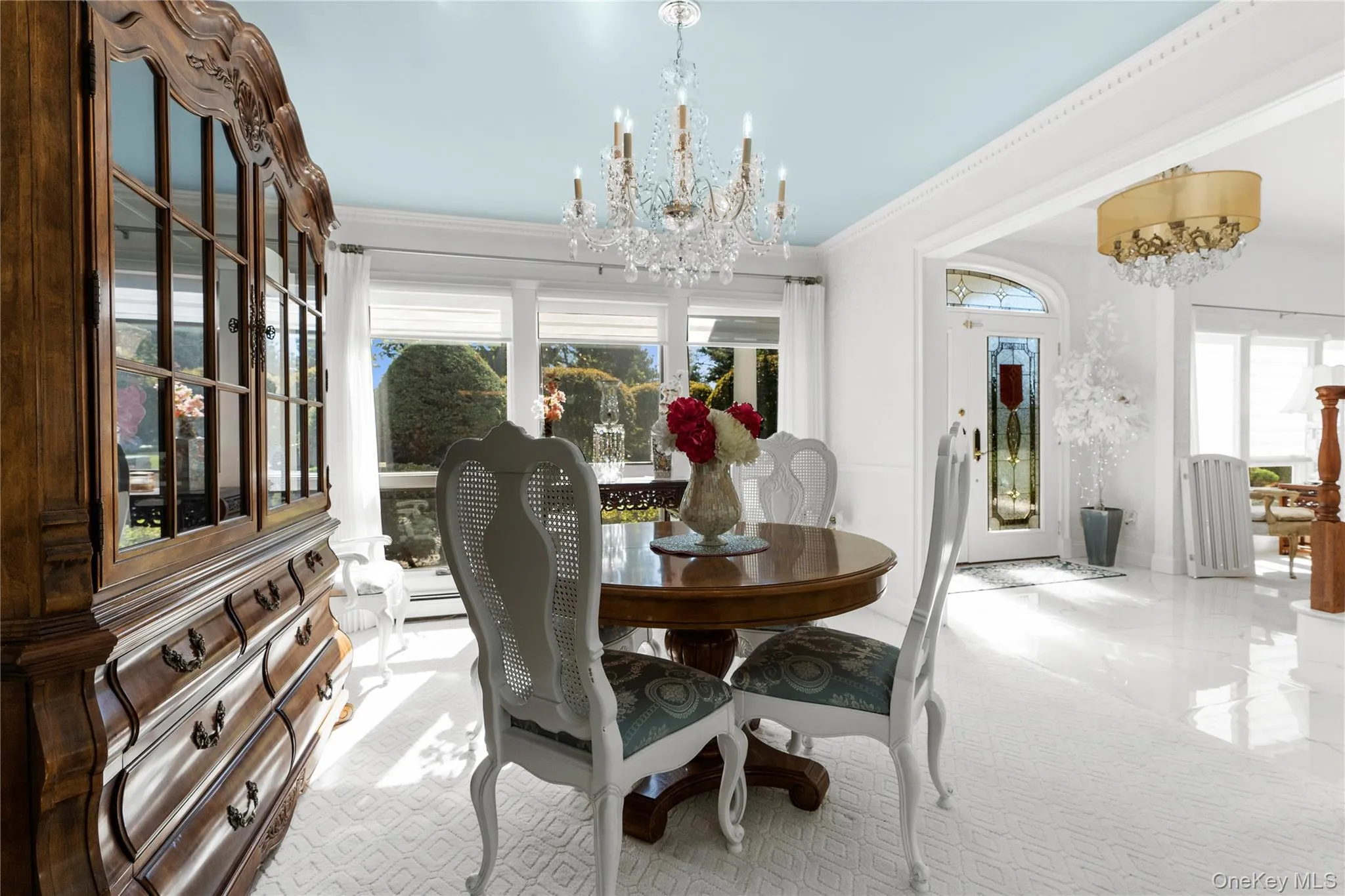 Dining area with a chandelier and crown molding Dining area with a chandelier and crown molding
