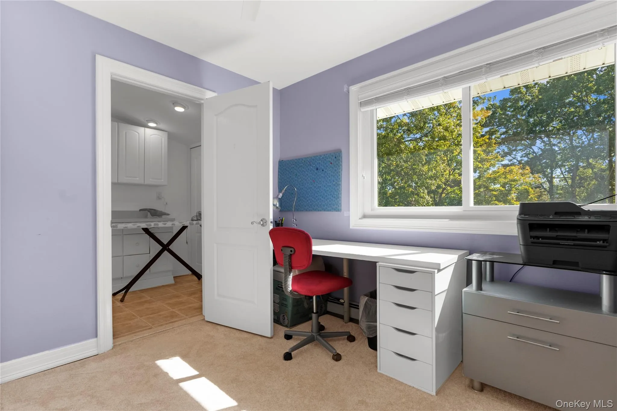 Office area with light colored carpet and baseboards Office area with light colored carpet and baseboards