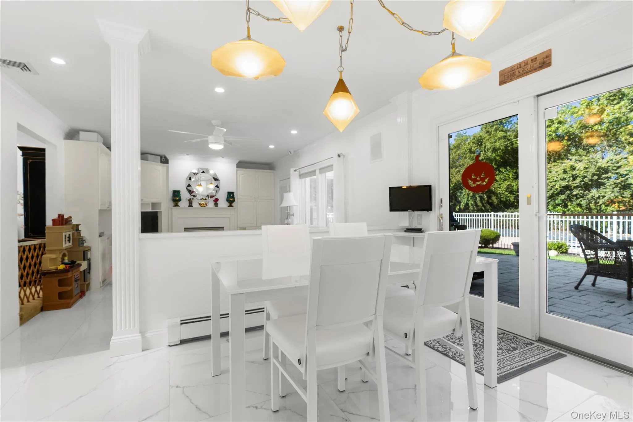 Dining room featuring light marble finish flooring, baseboard heating, recessed lighting, and a ceiling fan Dining room featuring light marble finish flooring, baseboard heating, recessed lighting, and a ceiling fan