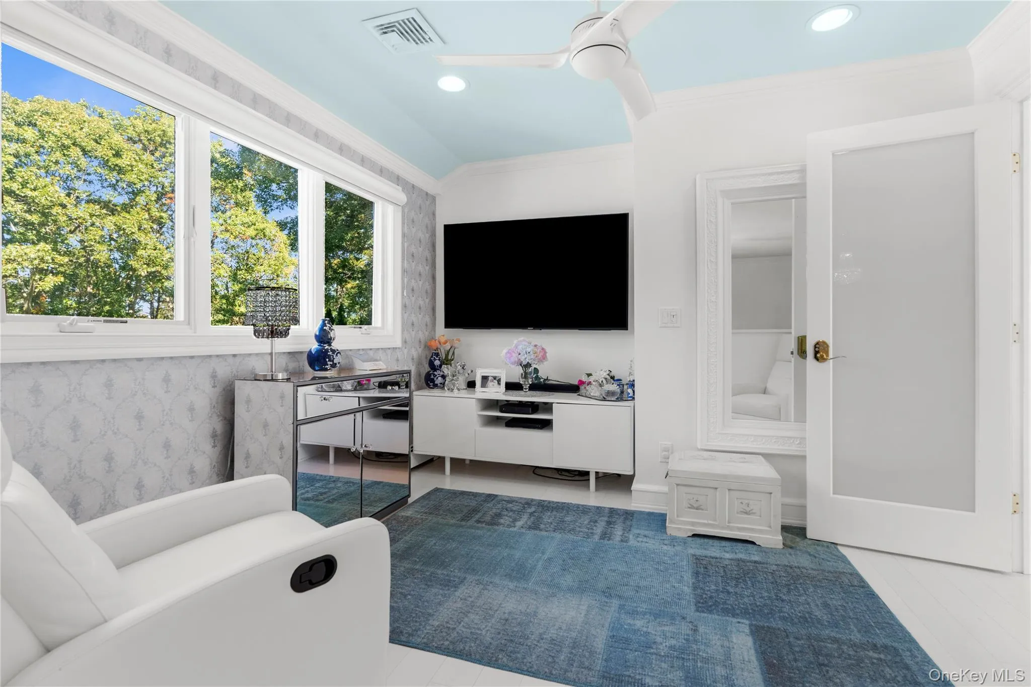 Living room with crown molding, ceiling fan, and recessed lighting Living room with crown molding, ceiling fan, and recessed lighting