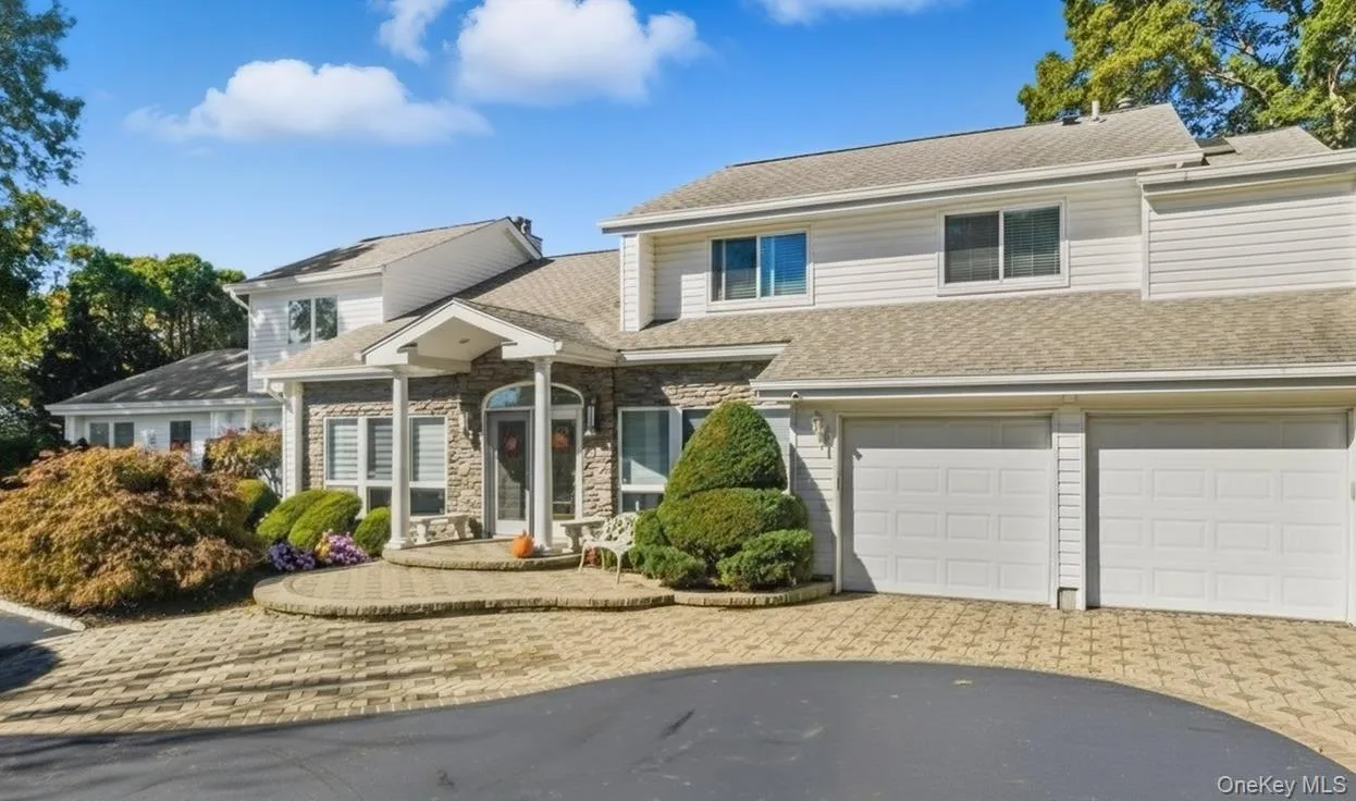 View of front of home featuring roof with shingles, decorative driveway, a garage, and stone siding View of front of home featuring roof with shingles, decorative driveway, a garage, and stone siding