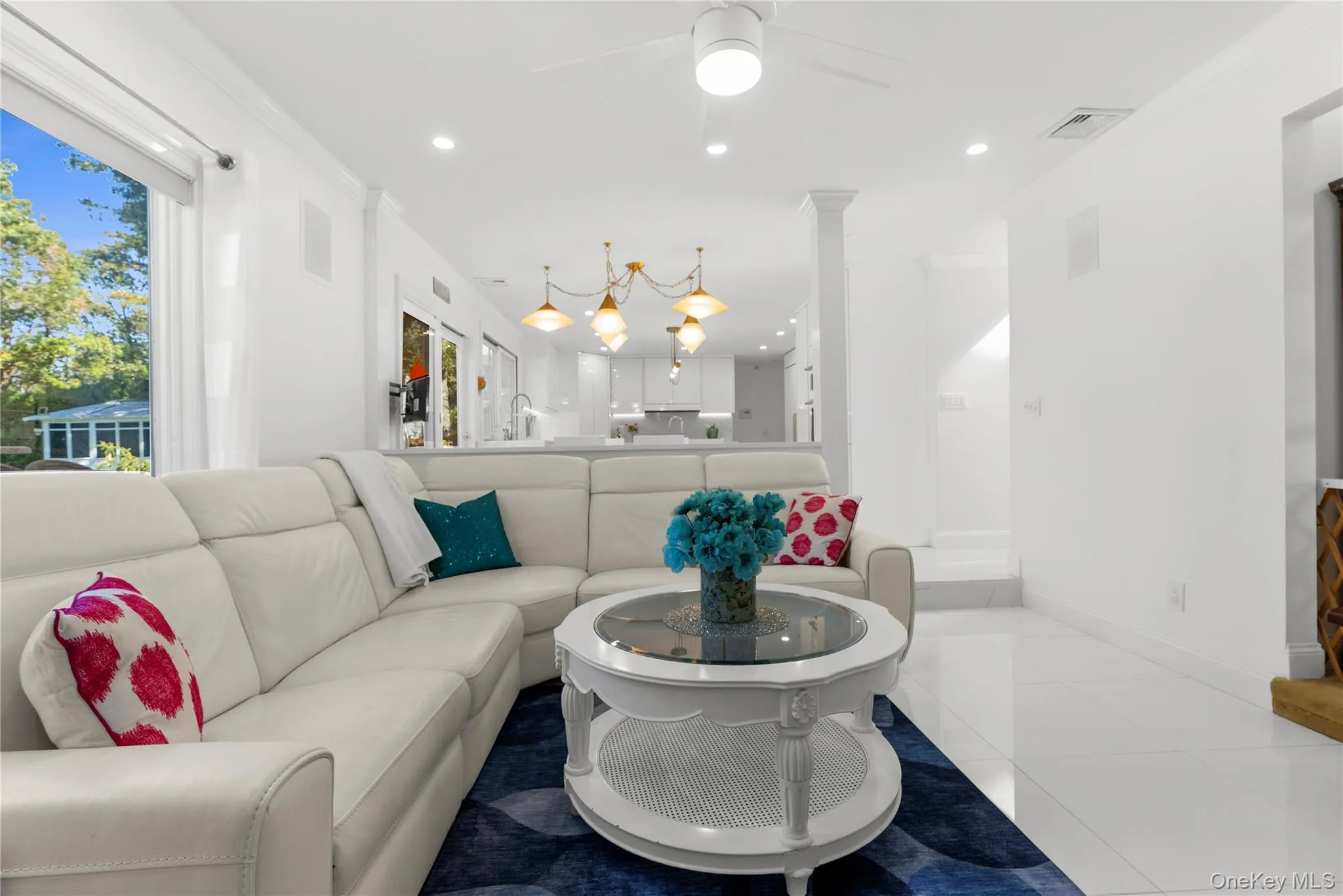 Tiled living area with crown molding, recessed lighting, and a ceiling fan Tiled living area with crown molding, recessed lighting, and a ceiling fan