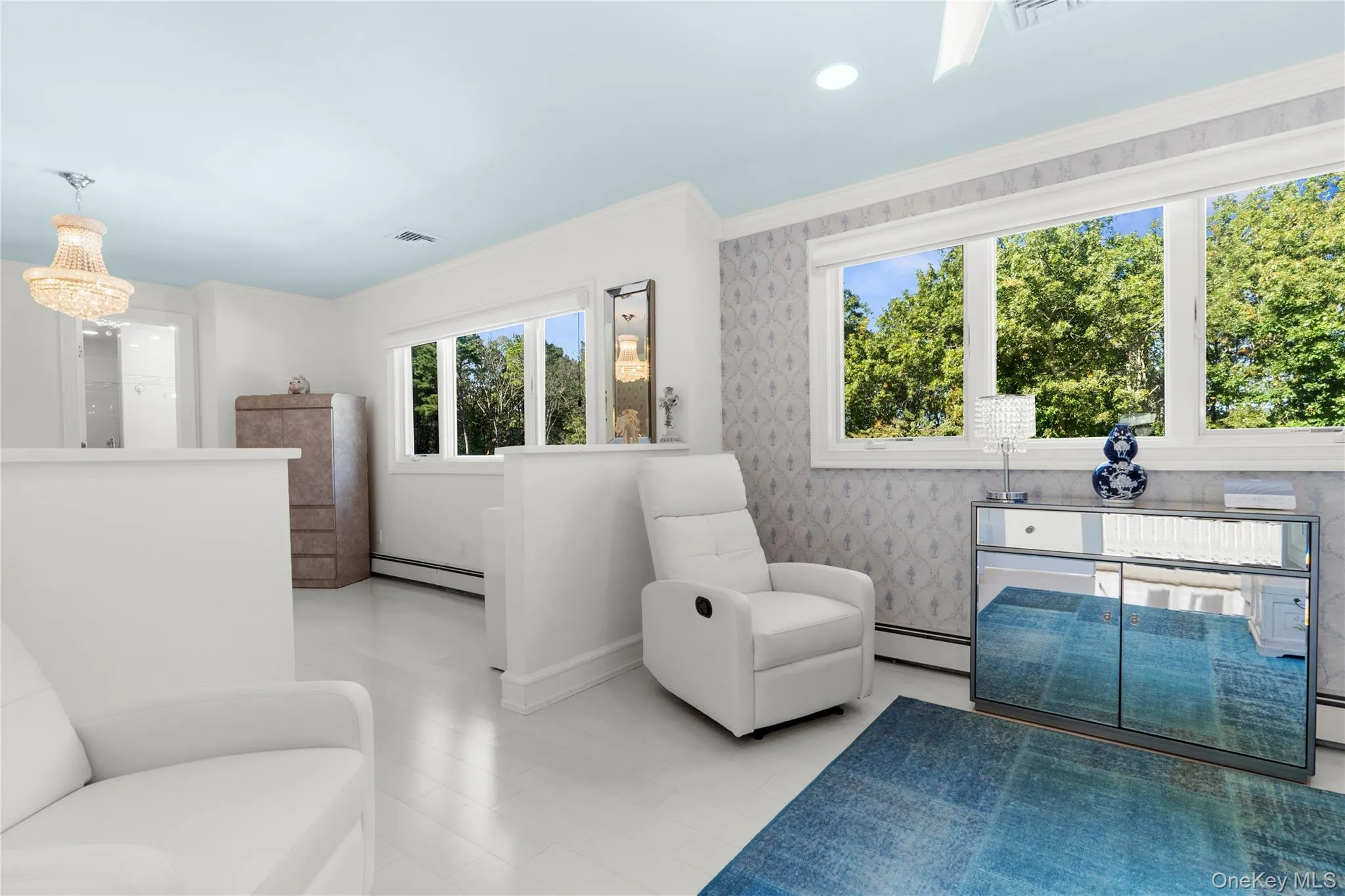 Sitting room featuring crown molding and recessed lighting Sitting room featuring crown molding and recessed lighting