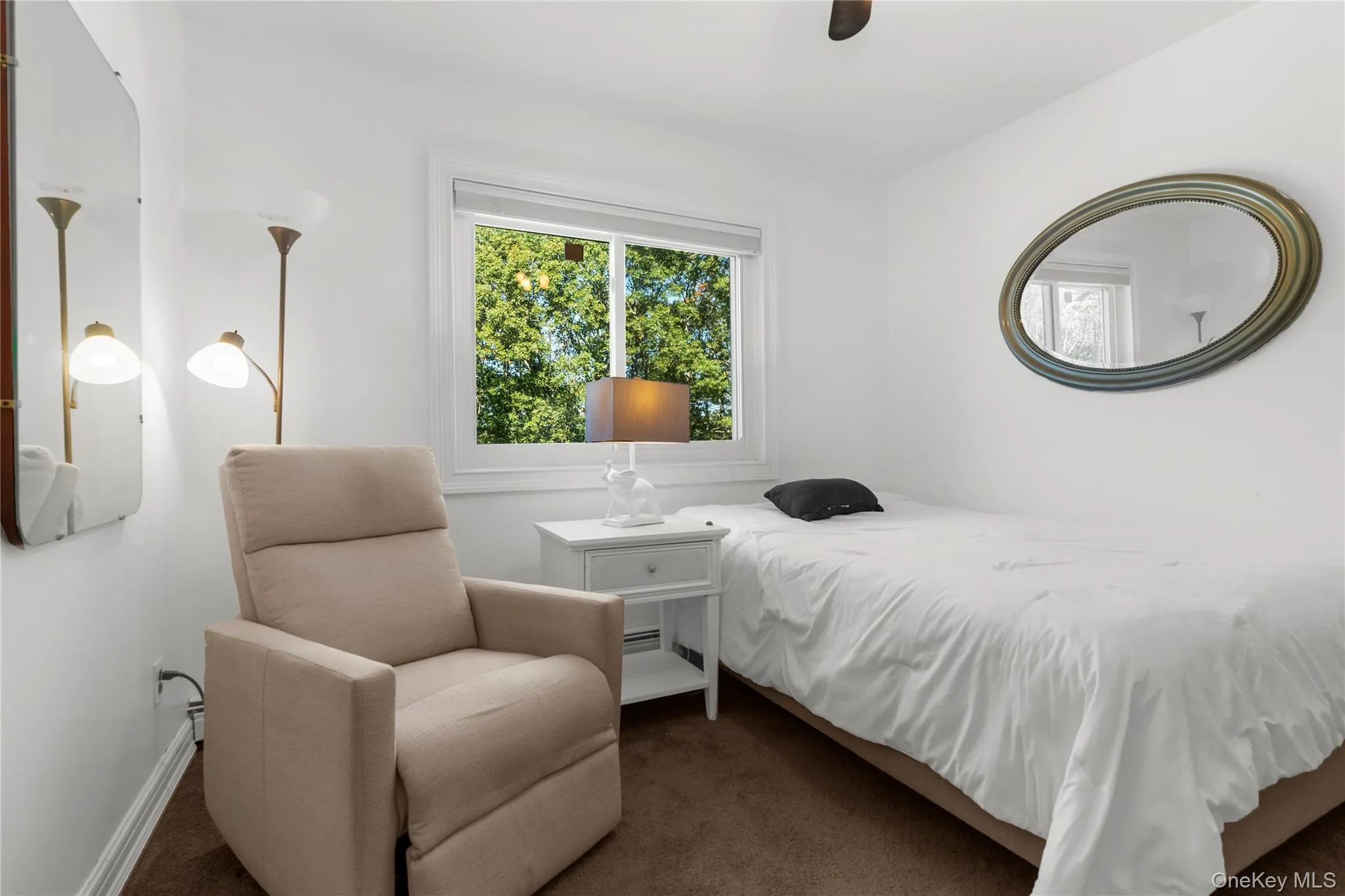 Carpeted bedroom with a ceiling fan Carpeted bedroom with a ceiling fan