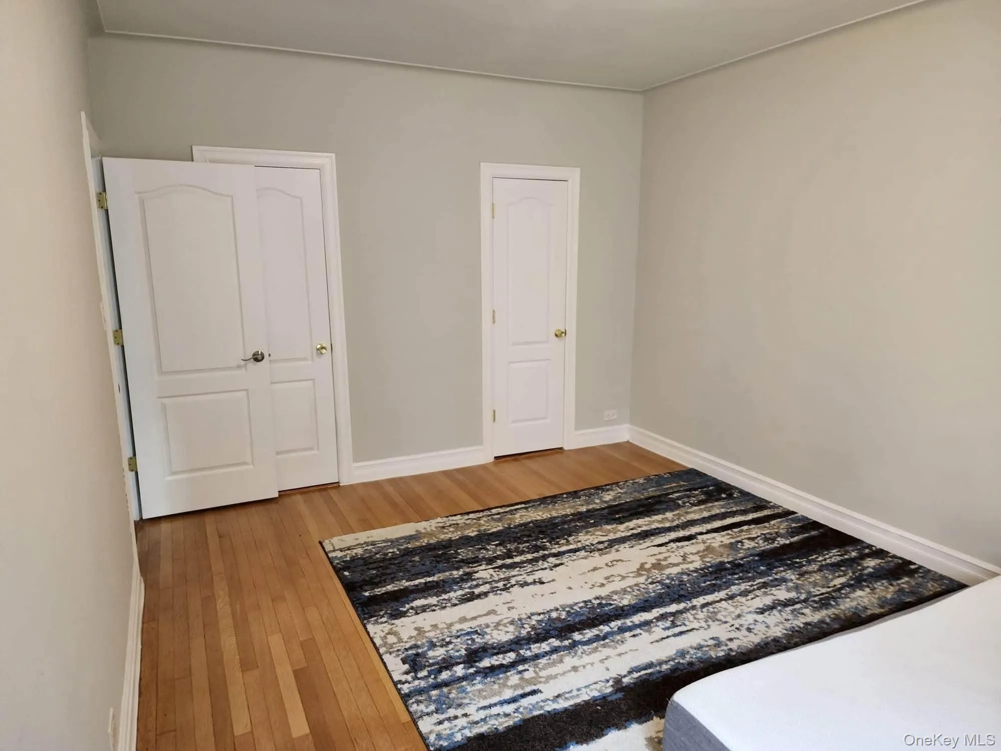 Unfurnished bedroom with light wood-type flooring and baseboards Unfurnished bedroom with light wood-type flooring and baseboards