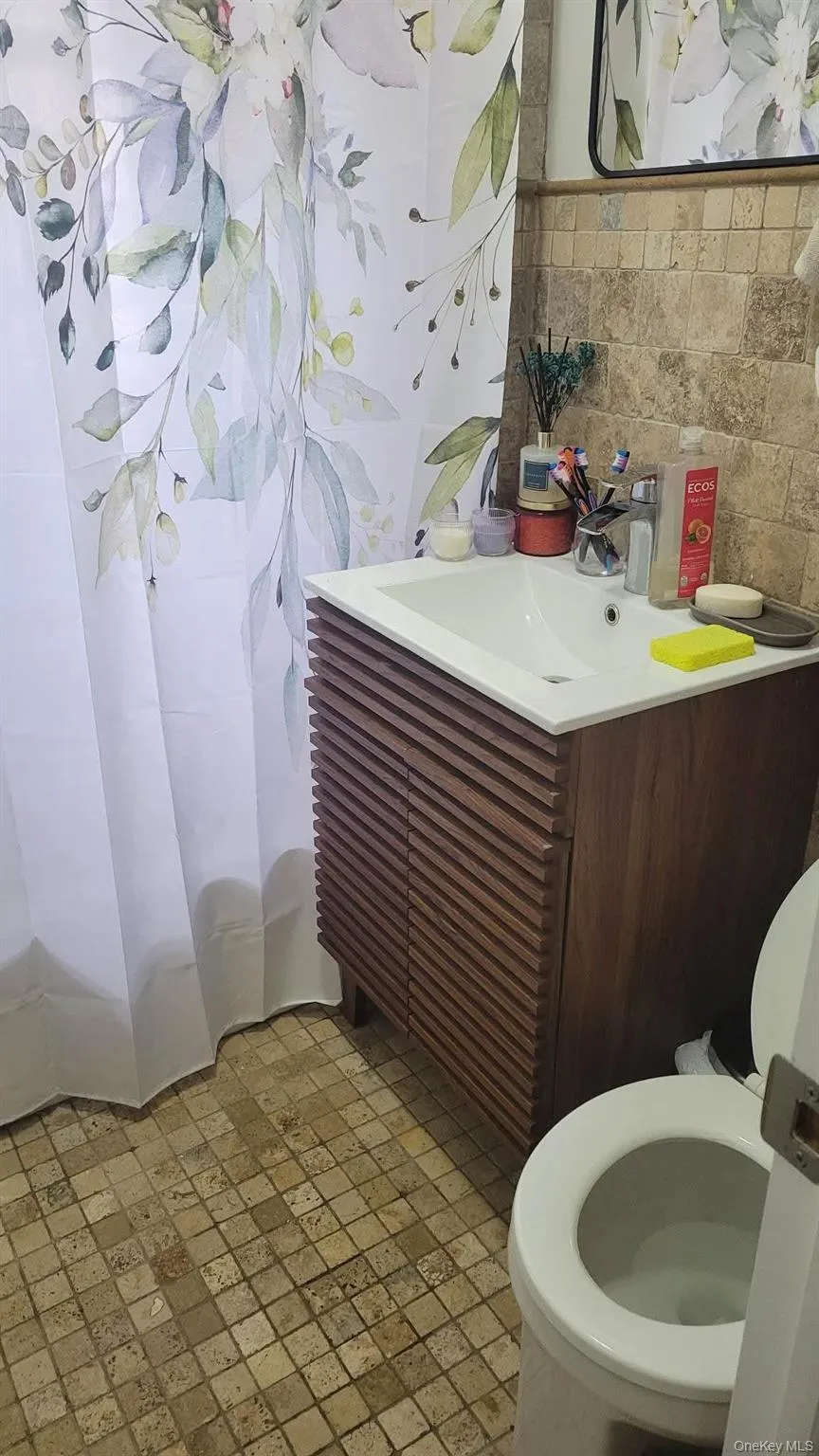 Full bath with vanity and tile walls Full bath with vanity and tile walls