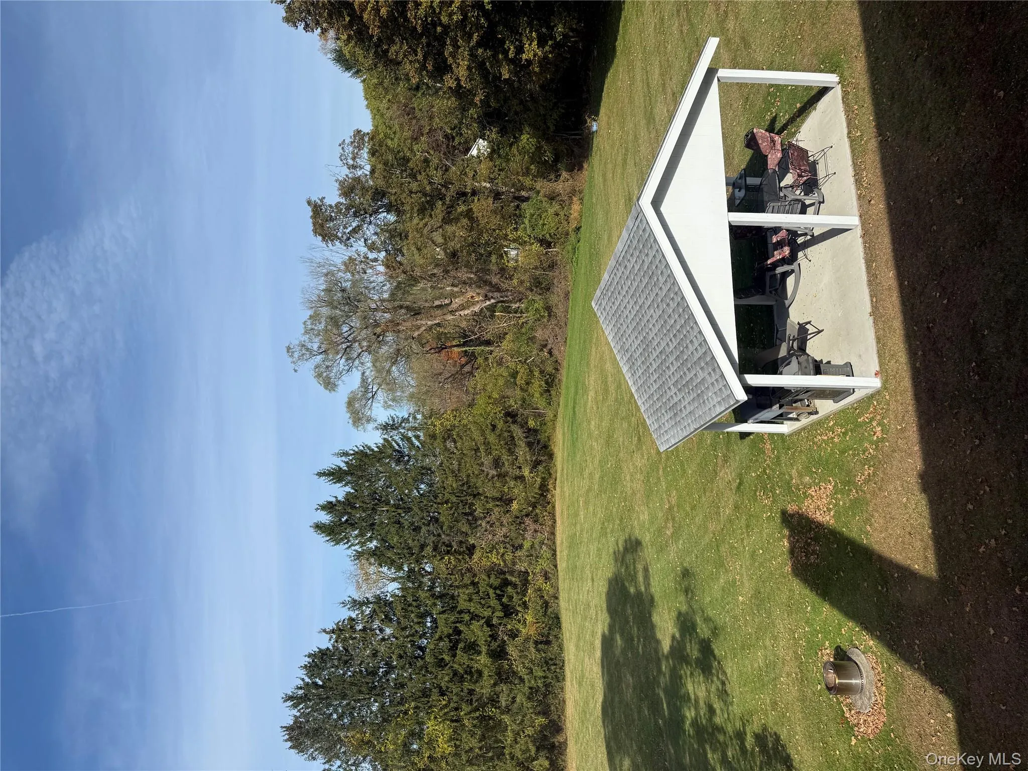 View of grassy yard with a patio and a forest view View of grassy yard with a patio and a forest view