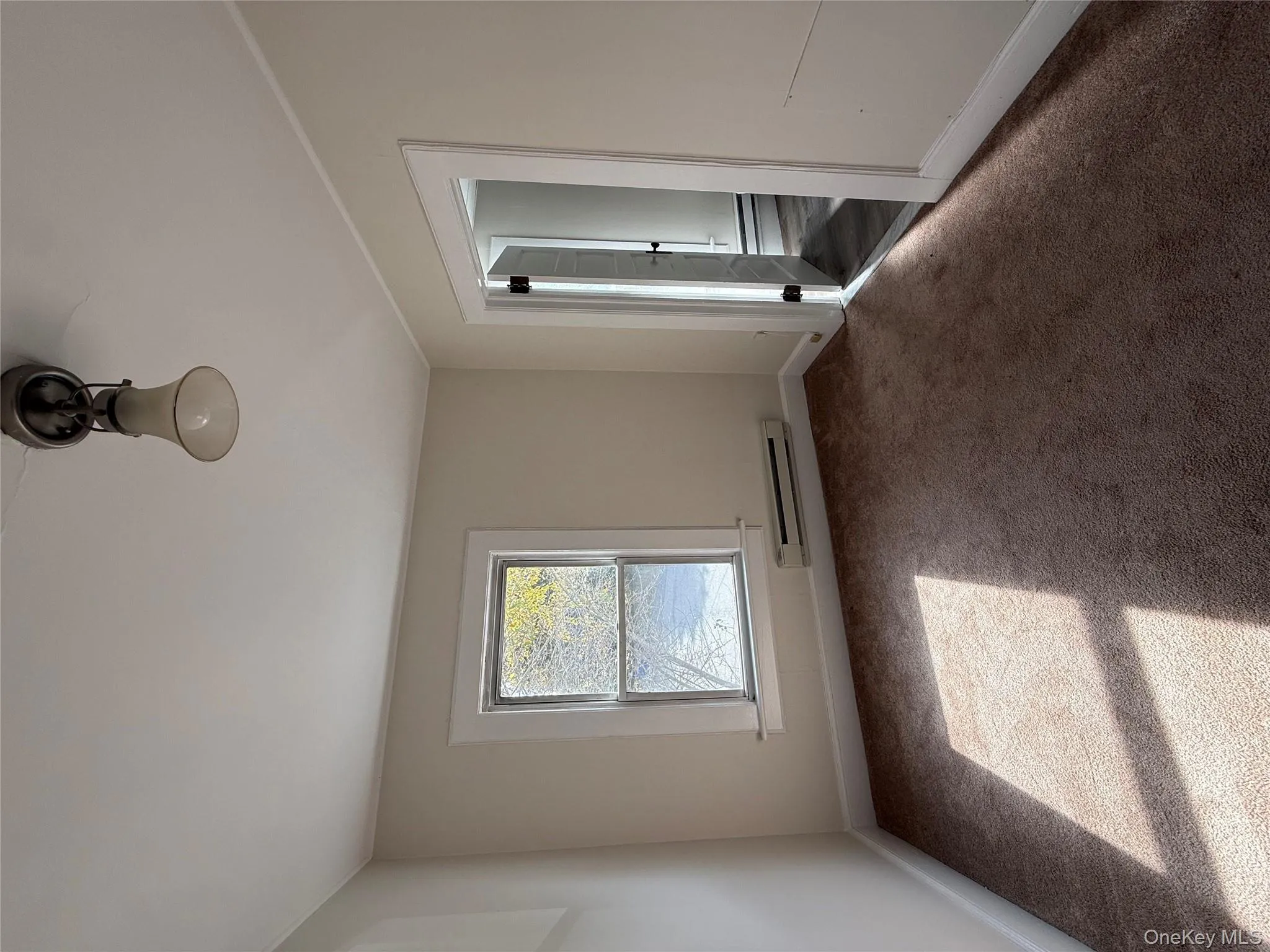 Unfurnished room with carpet, a baseboard heating unit, and ornamental molding Unfurnished room with carpet, a baseboard heating unit, and ornamental molding