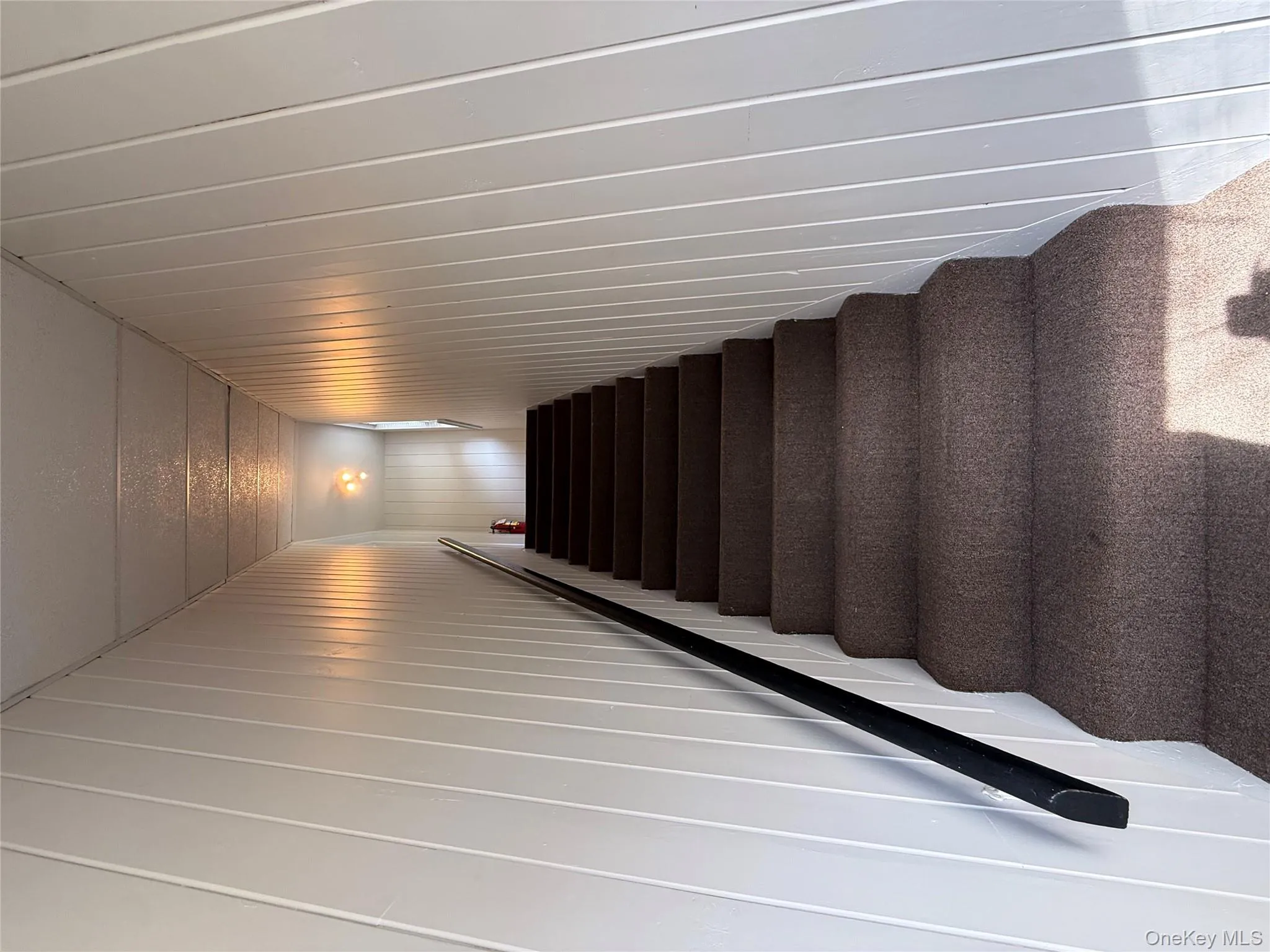 Staircase featuring wooden walls Staircase featuring wooden walls