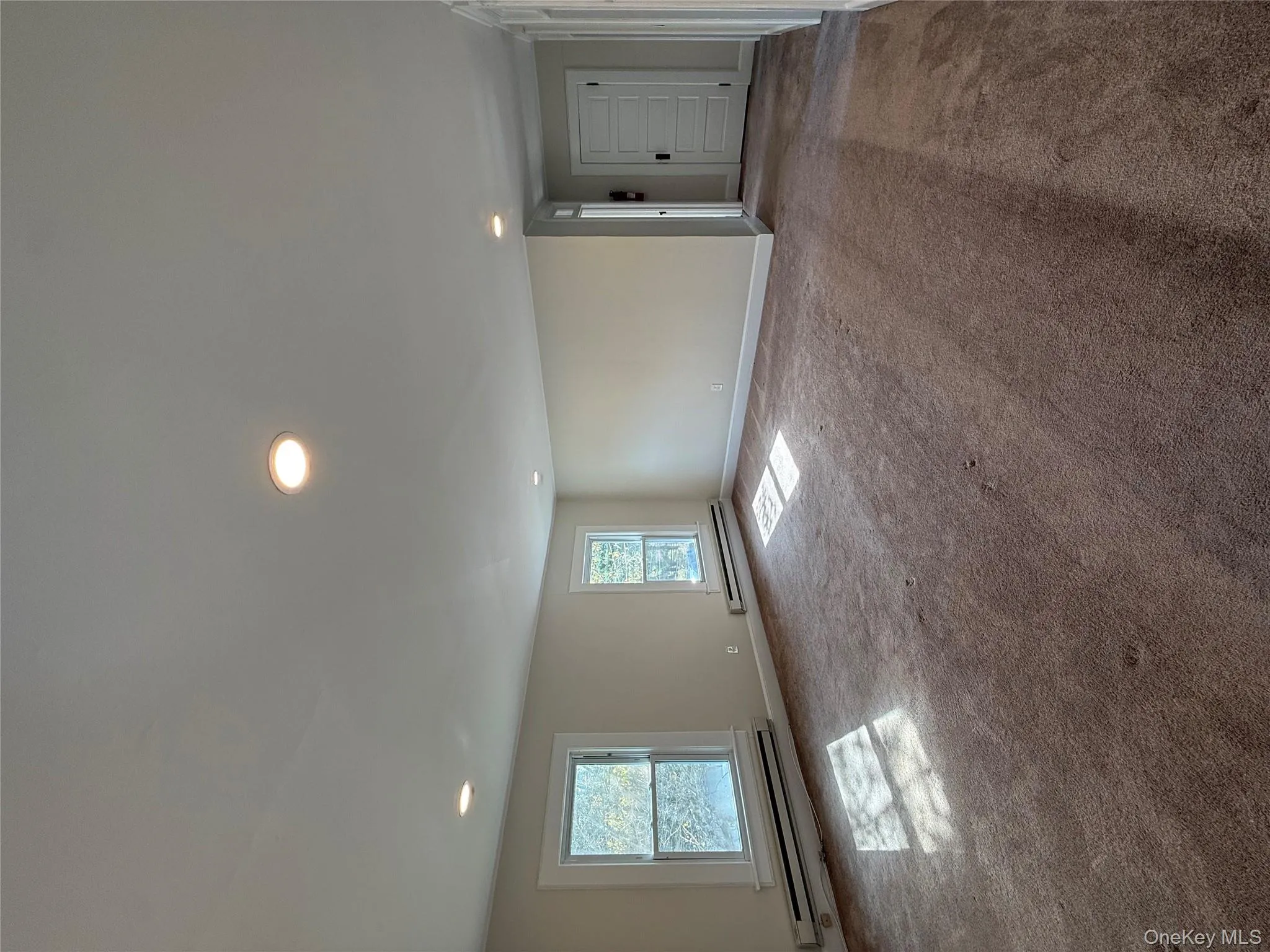 Carpeted spare room with recessed lighting and baseboard heating Carpeted spare room with recessed lighting and baseboard heating