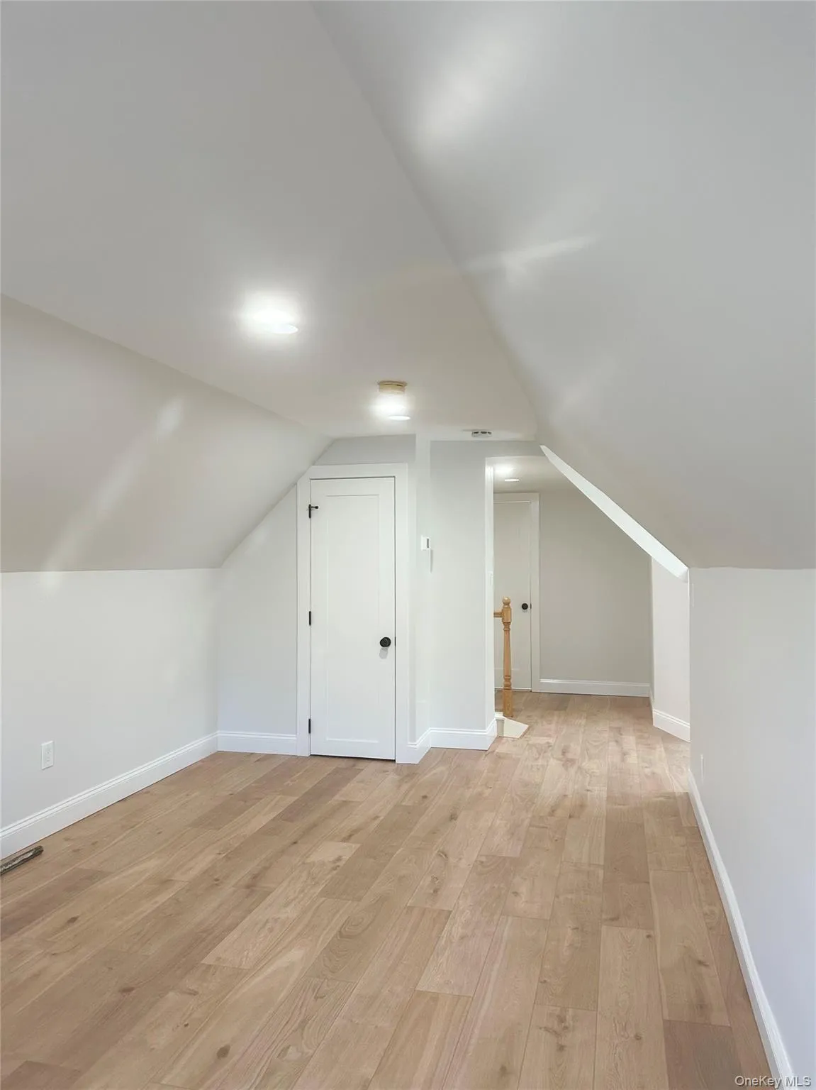 Bonus room with light wood-type flooring and vaulted ceiling Bonus room with light wood-type flooring and vaulted ceiling