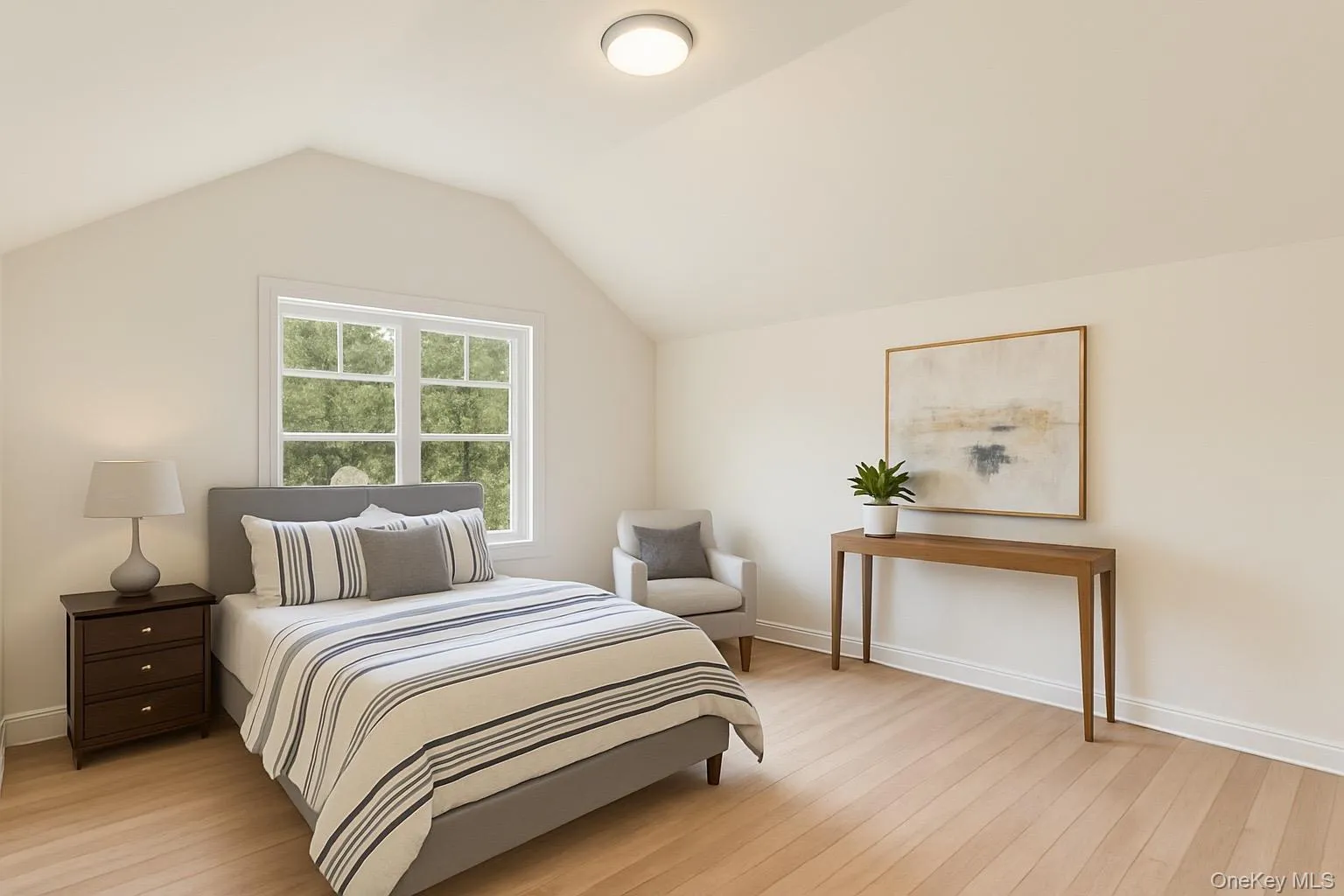 Bedroom with lofted ceiling and light wood-style flooring Bedroom with lofted ceiling and light wood-style flooring