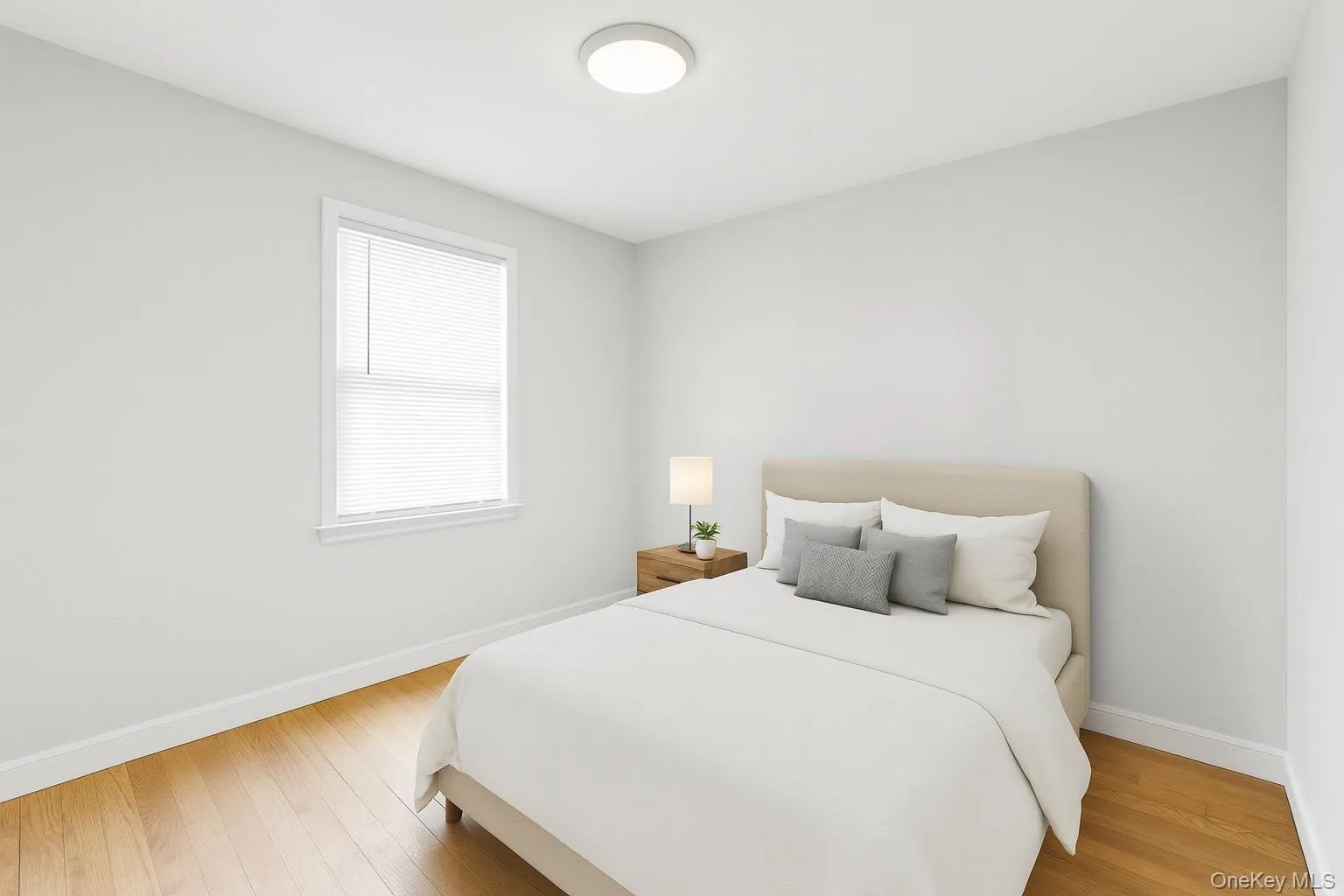 Bedroom with baseboards and light wood-type flooring Bedroom with baseboards and light wood-type flooring