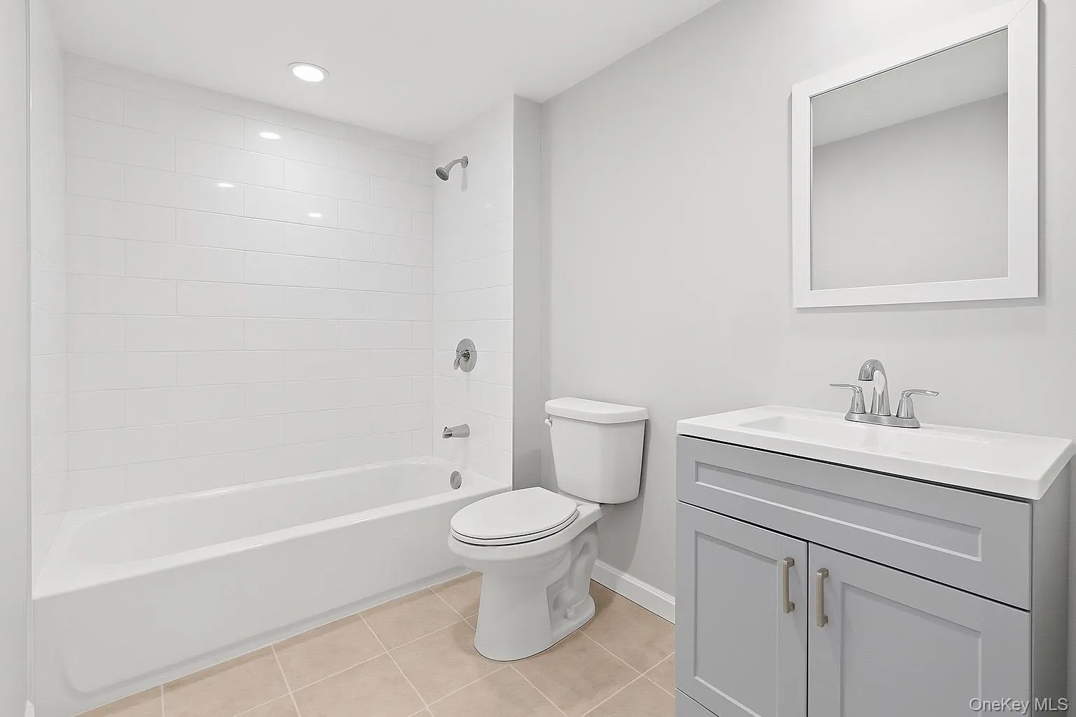 Bathroom featuring vanity, light tile patterned floors, bathtub / shower combination, and recessed lighting Bathroom featuring vanity, light tile patterned floors, bathtub / shower combination, and recessed lighting
