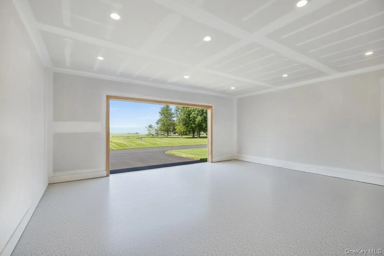 Empty room featuring recessed lighting and speckle patterned floor Empty room featuring recessed lighting and speckle patterned floor