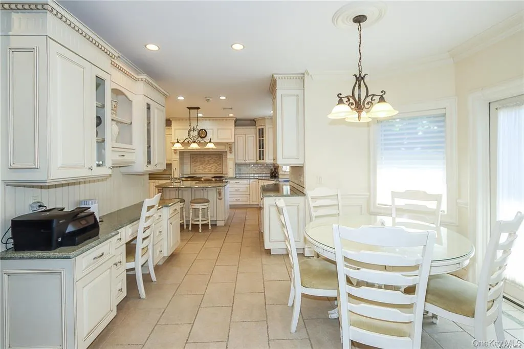 Dining area featuring light tile patterned floors, recessed lighting, a chandelier, and crown molding Dining area featuring light tile patterned floors, recessed lighting, a chandelier, and crown molding