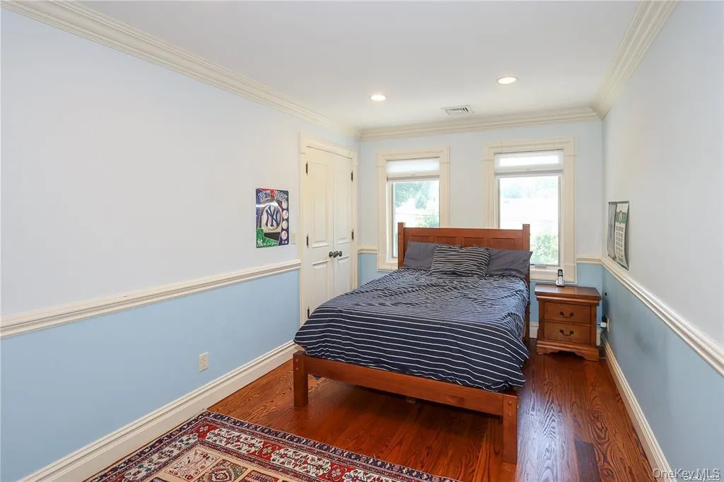 Bedroom featuring crown molding, wood finished floors, and recessed lighting Bedroom featuring crown molding, wood finished floors, and recessed lighting