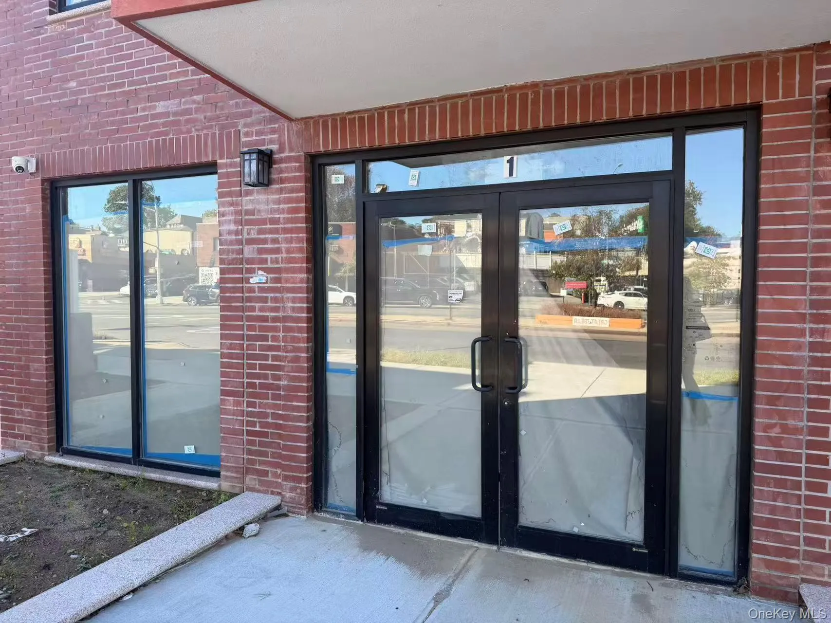Doorway to property featuring brick siding and french doors Doorway to property featuring brick siding and french doors