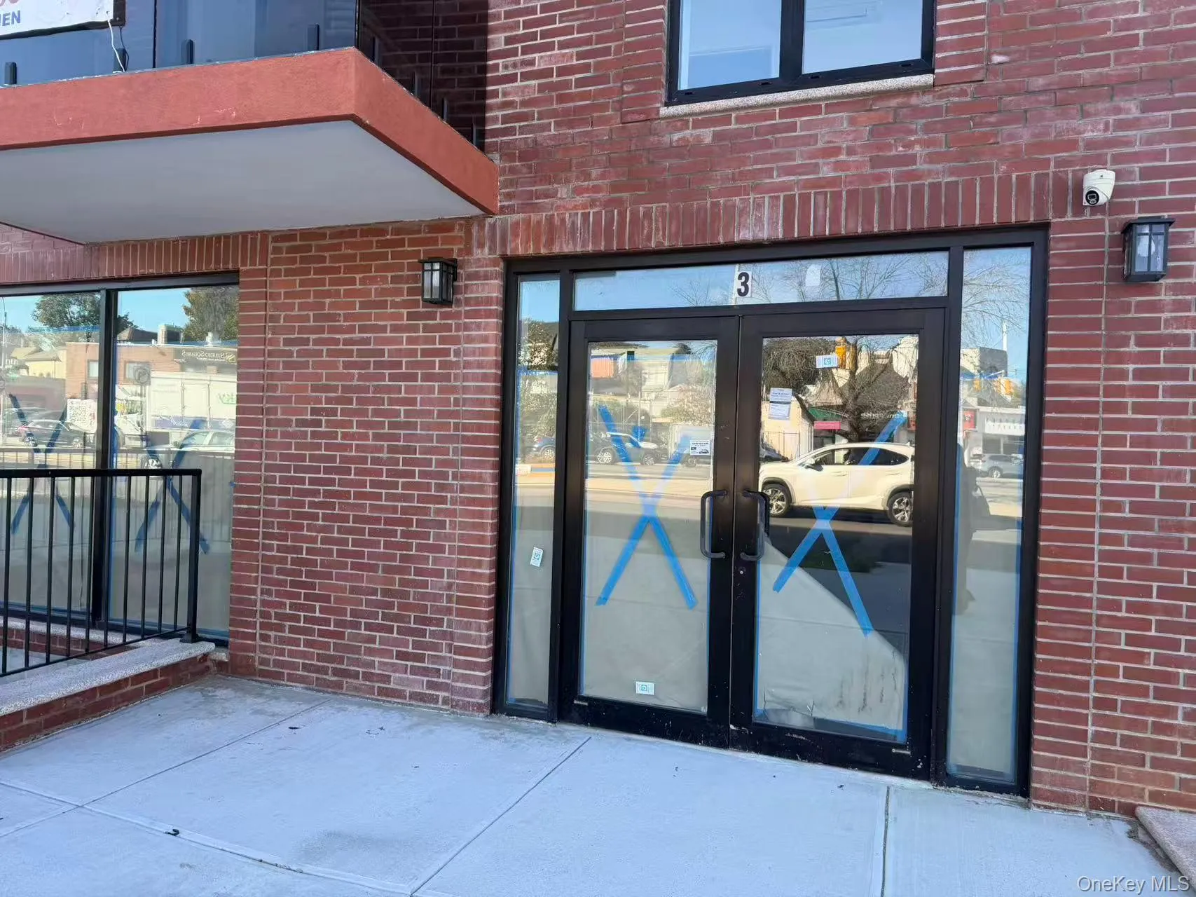 Doorway to property featuring brick siding and french doors Doorway to property featuring brick siding and french doors