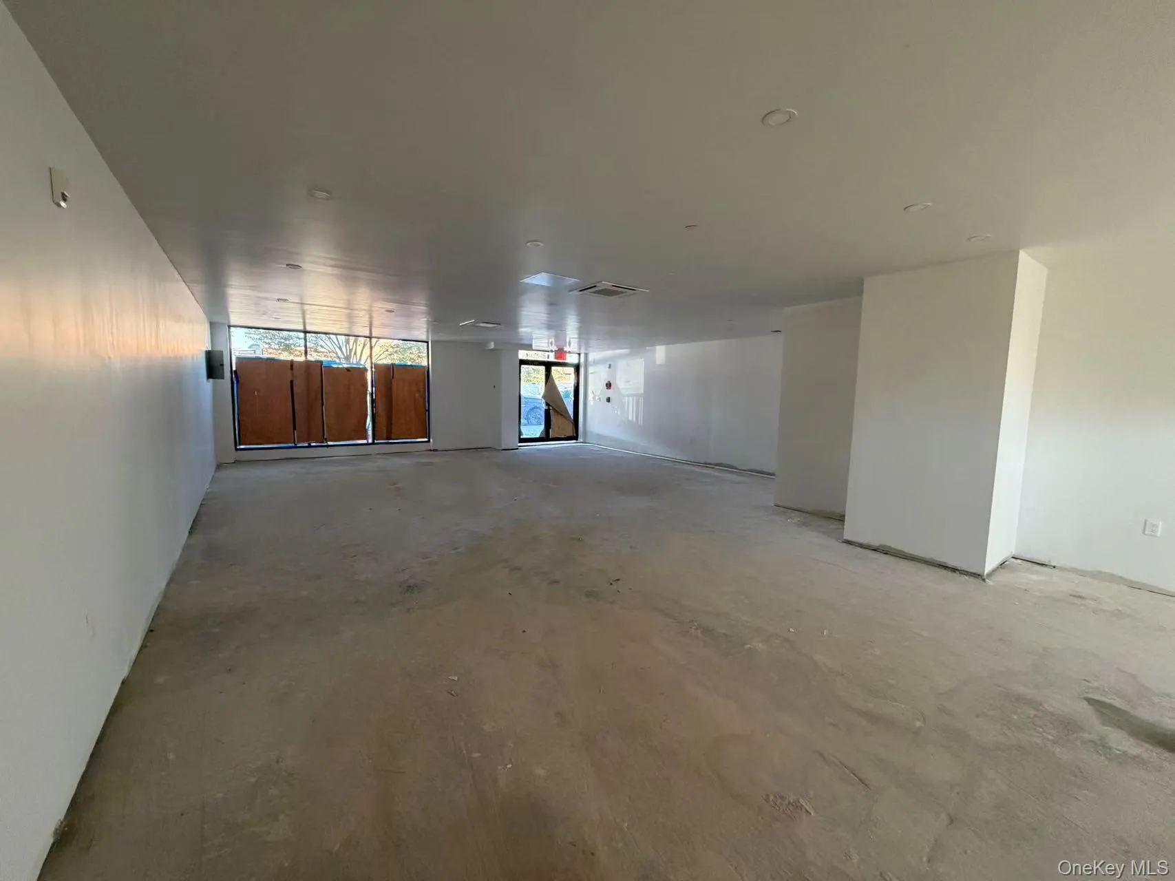 Spare room with unfinished concrete floors Spare room with unfinished concrete floors