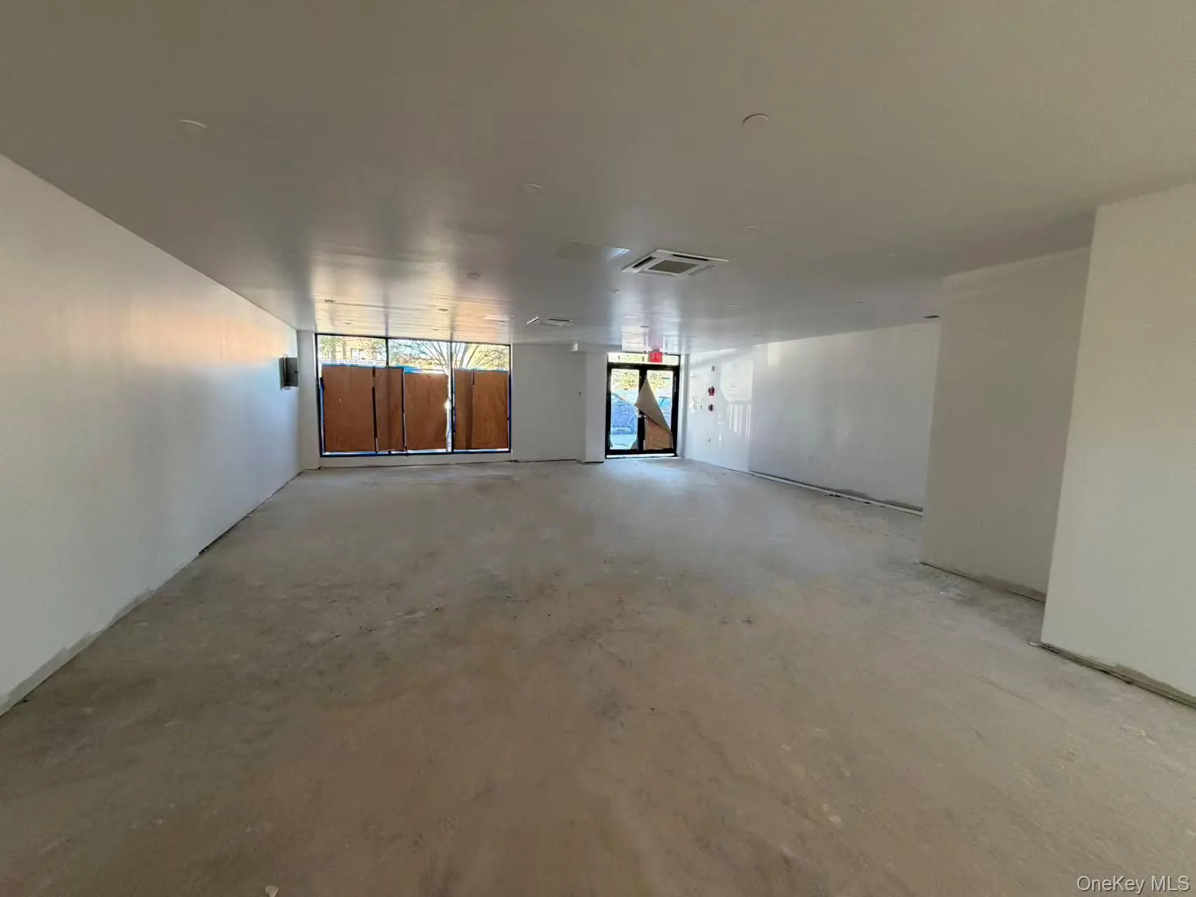 Empty room featuring unfinished concrete floors Empty room featuring unfinished concrete floors
