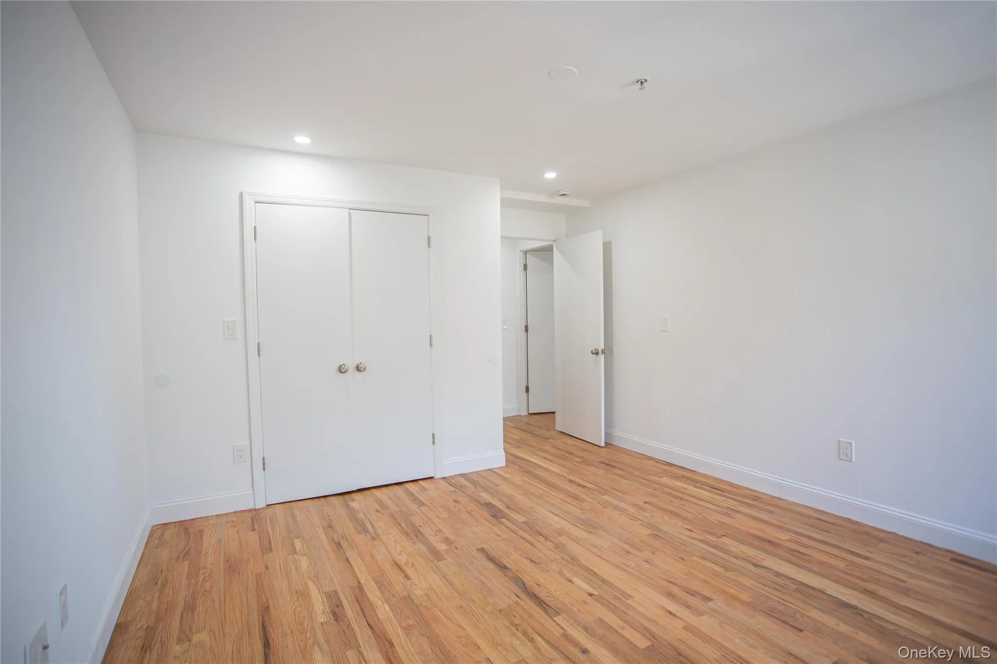 Unfurnished bedroom featuring light wood-style floors, recessed lighting, and a closet Unfurnished bedroom featuring light wood-style floors, recessed lighting, and a closet