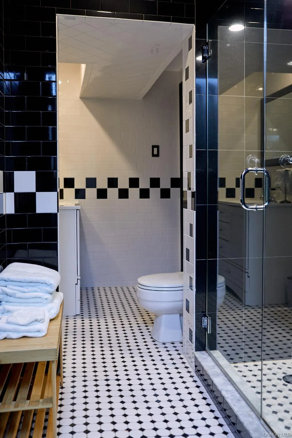 Bathroom with tile walls, a stall shower, and tile patterned floors Bathroom with tile walls, a stall shower, and tile patterned floors