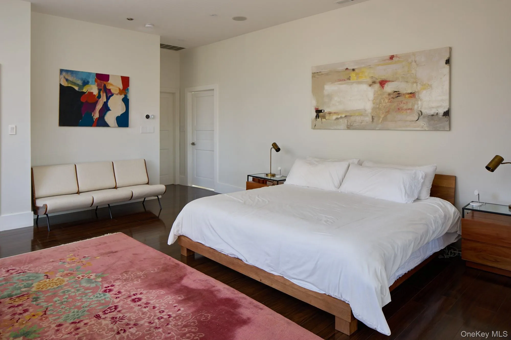 Bedroom with dark wood-style flooring and baseboards Bedroom with dark wood-style flooring and baseboards