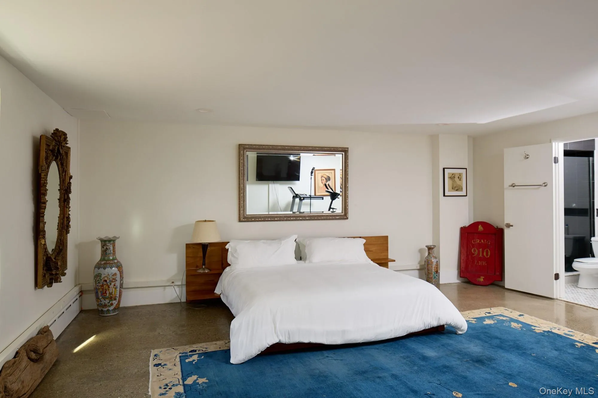 Bedroom with a baseboard radiator and ensuite bath Bedroom with a baseboard radiator and ensuite bath