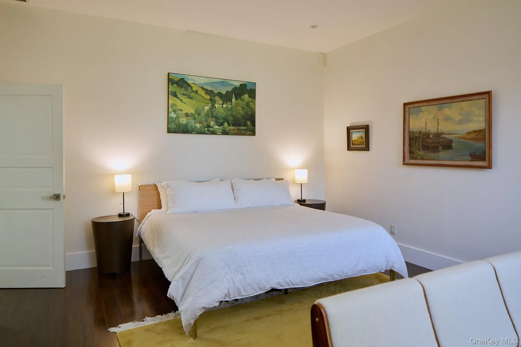 Bedroom with dark wood finished floors and baseboards Bedroom with dark wood finished floors and baseboards