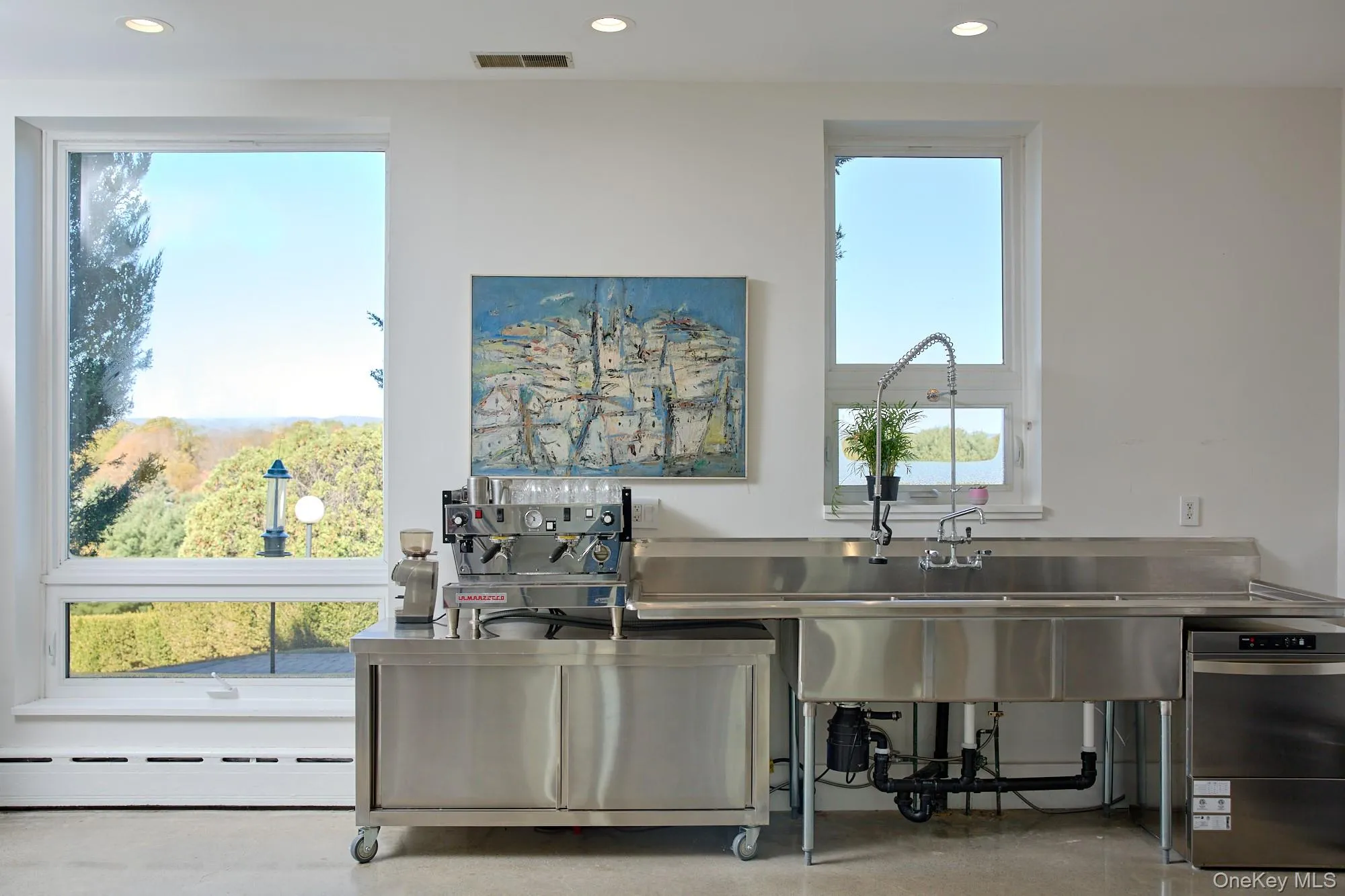 Kitchen featuring stainless steel counters, a baseboard heating unit, recessed lighting, and dishwasher Kitchen featuring stainless steel counters, a baseboard heating unit, recessed lighting, and dishwasher