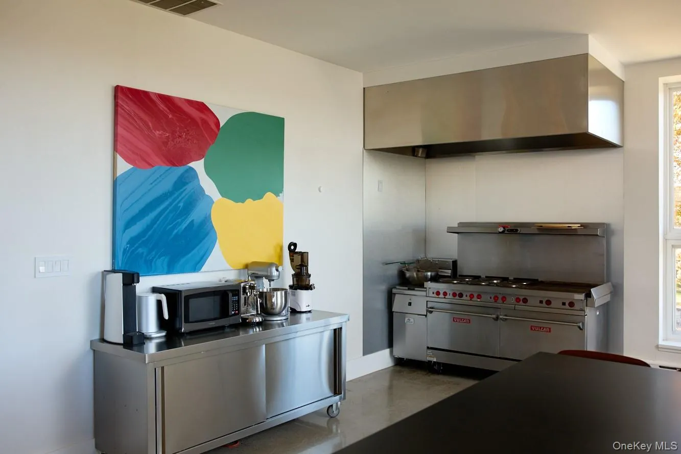 Kitchen featuring ventilation hood and stainless steel appliances Kitchen featuring ventilation hood and stainless steel appliances
