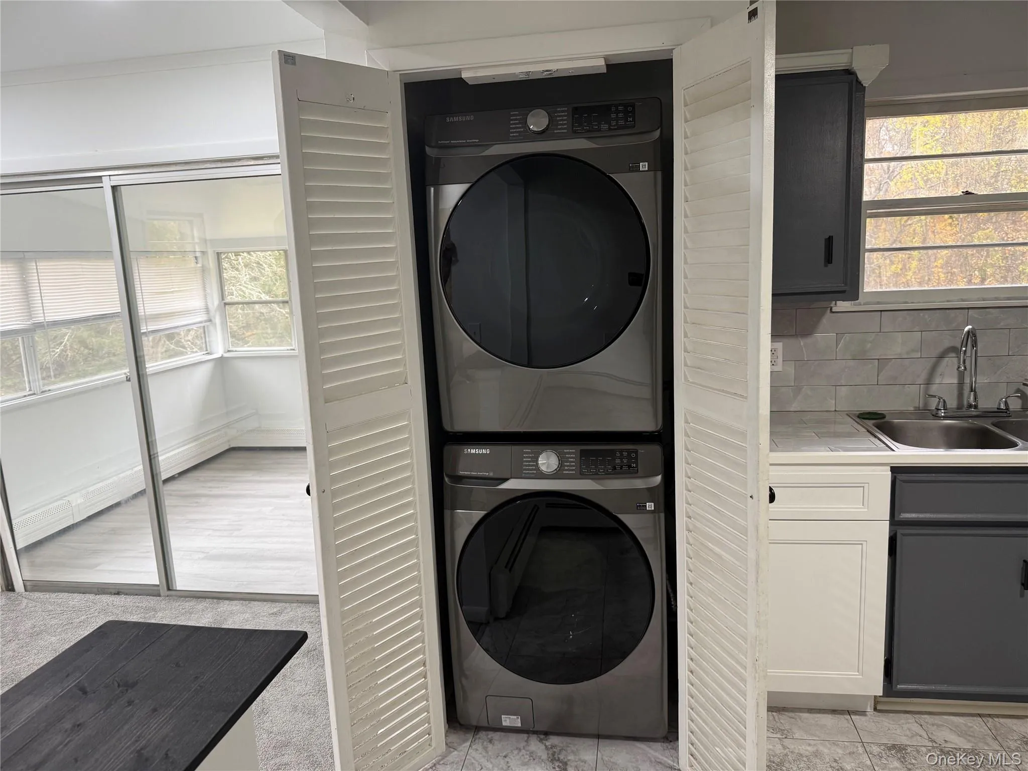Washroom with stacked washer and clothes dryer Washroom with stacked washer and clothes dryer