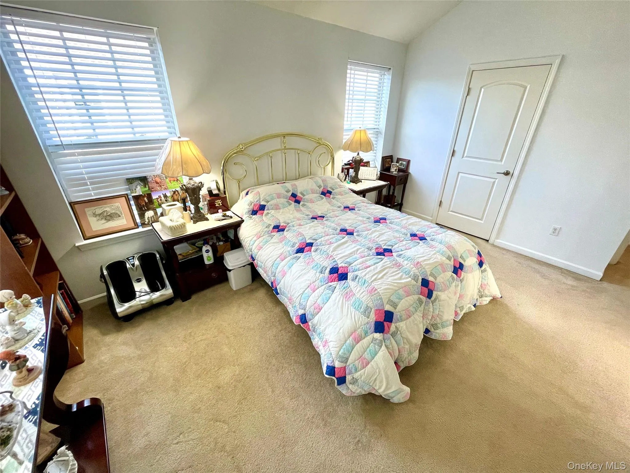 Bedroom with light carpet and lofted ceiling Bedroom with light carpet and lofted ceiling