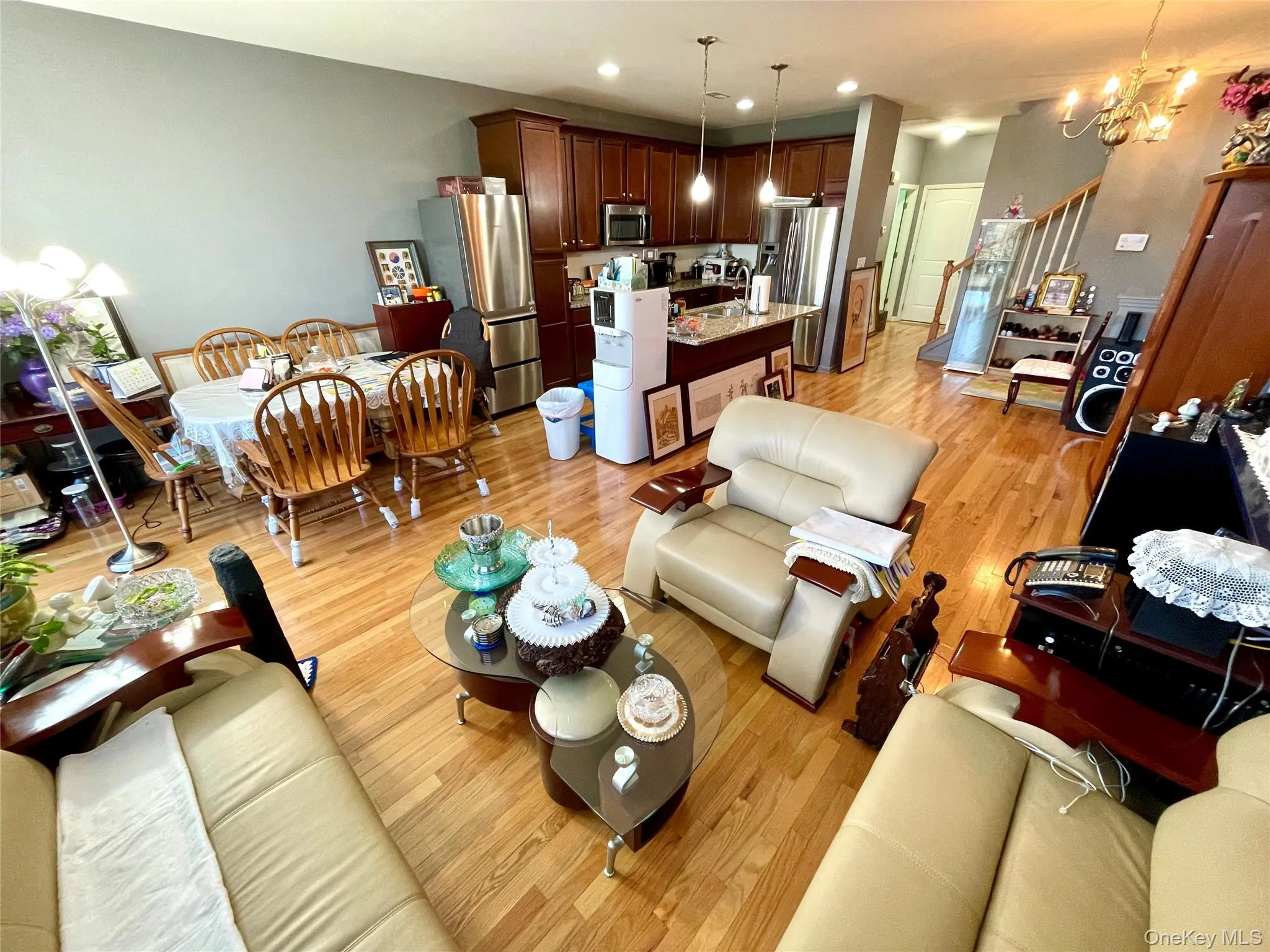 Living area featuring light wood finished floors, a chandelier, stairs, and recessed lighting Living area featuring light wood finished floors, a chandelier, stairs, and recessed lighting