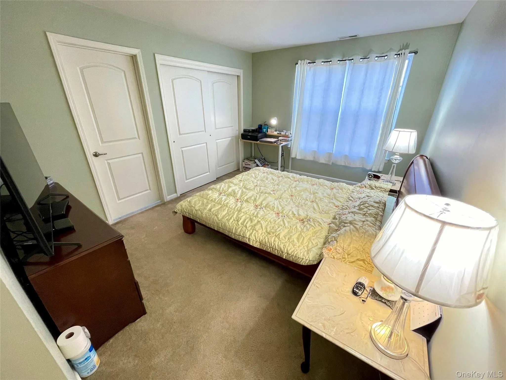 Carpeted bedroom featuring a closet Carpeted bedroom featuring a closet