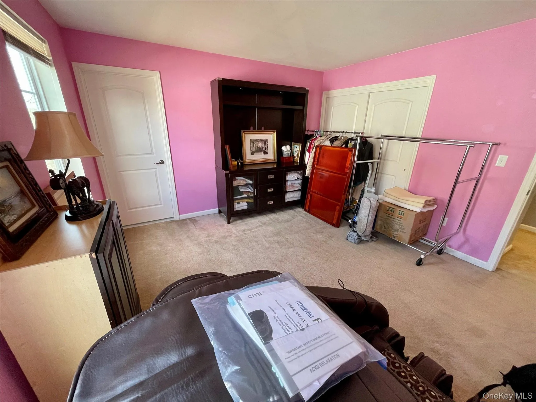 Bedroom featuring light colored carpet and a closet Bedroom featuring light colored carpet and a closet
