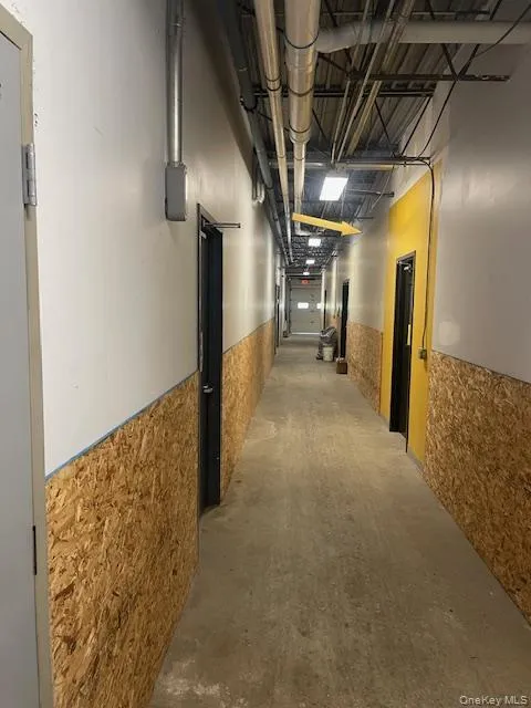 Hallway featuring wainscoting Hallway featuring wainscoting