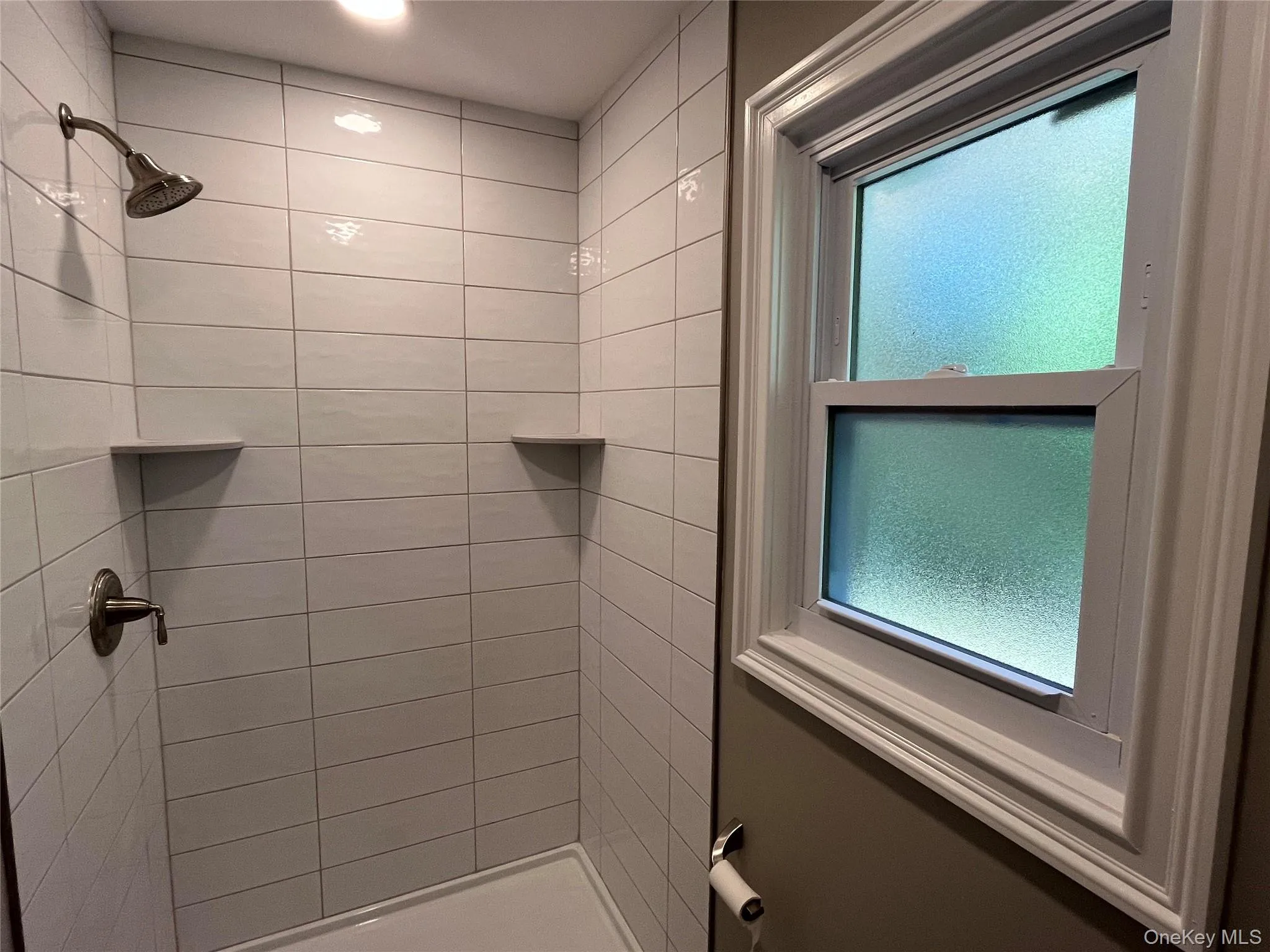 Bathroom with a stall shower and healthy amount of natural light Bathroom with a stall shower and healthy amount of natural light