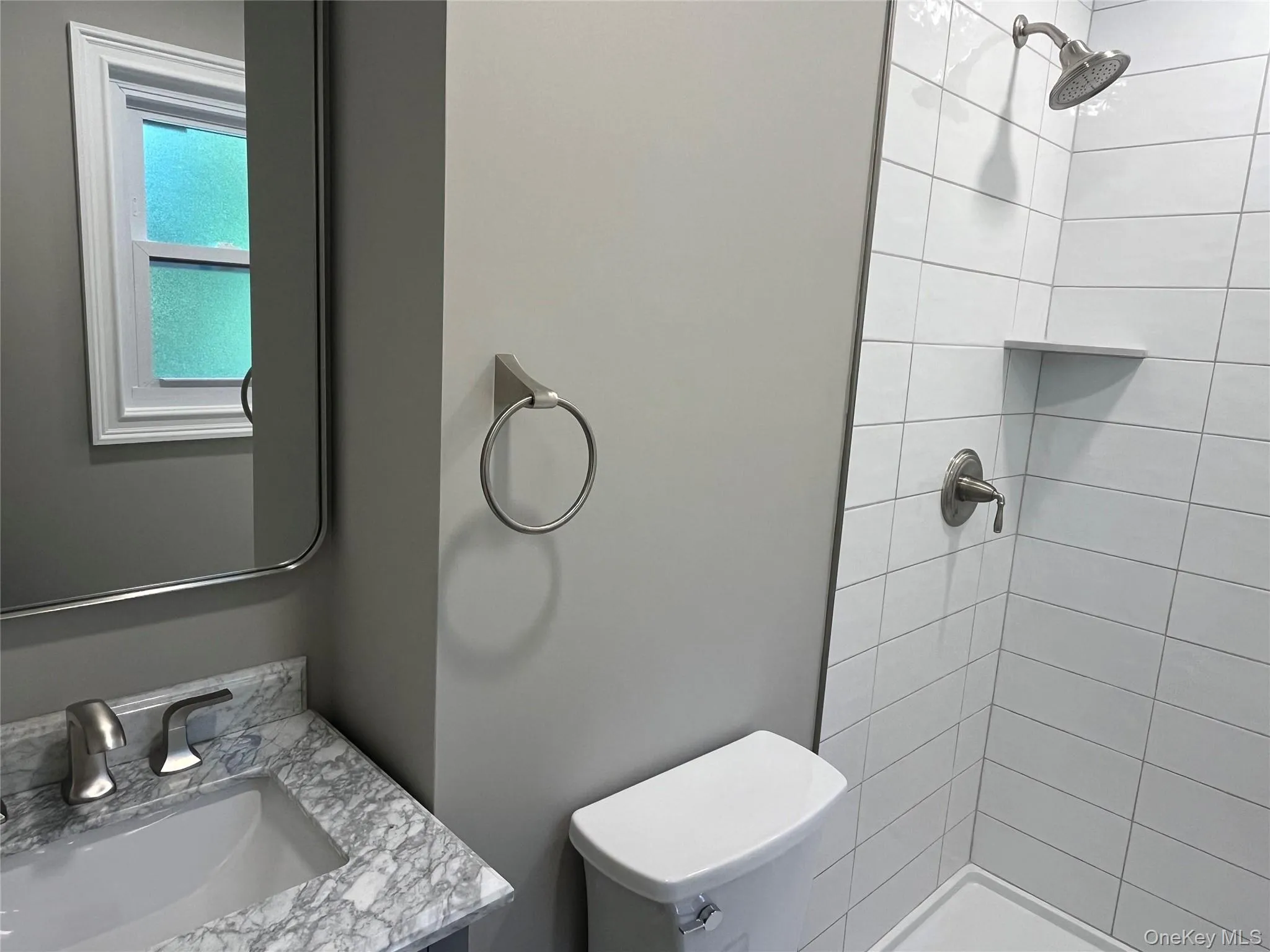 Bathroom featuring a stall shower and vanity Bathroom featuring a stall shower and vanity